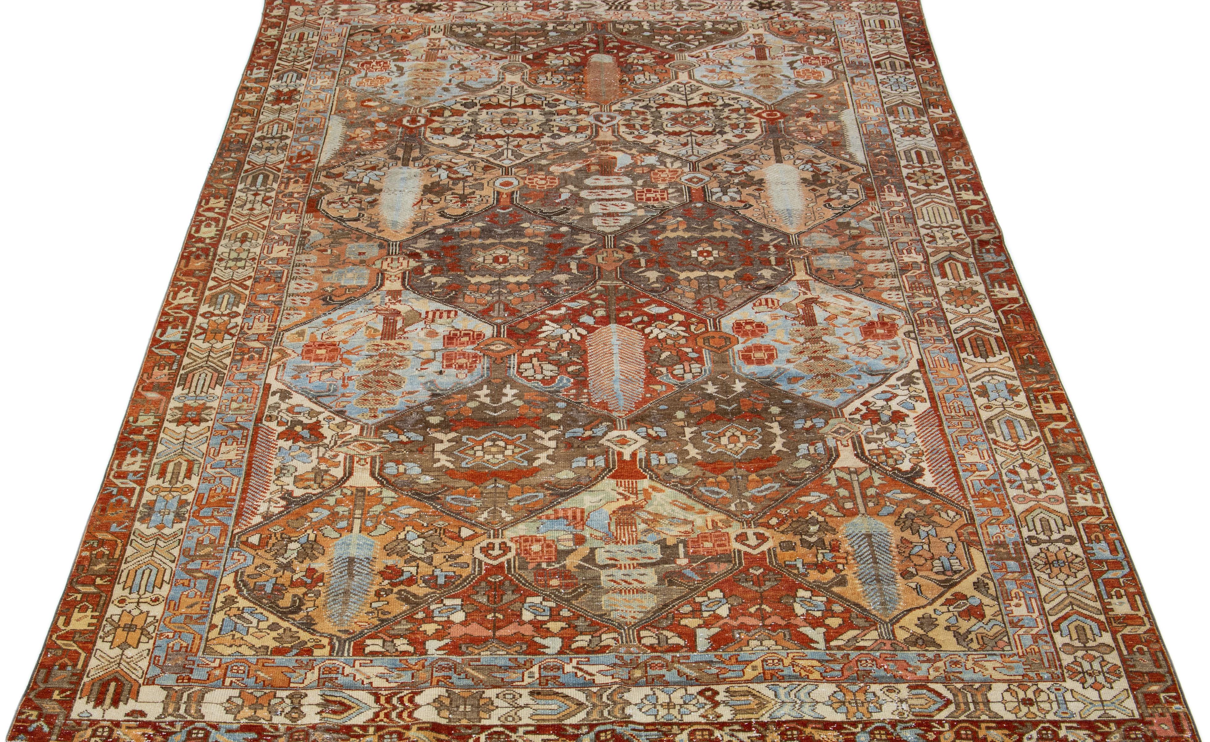 Beautiful Antique Bakhtiari hand-knotted wool rug with a gray color field. This Persian piece has a classic geometric floral design in blue and rust colors.

This rug measures 6'10