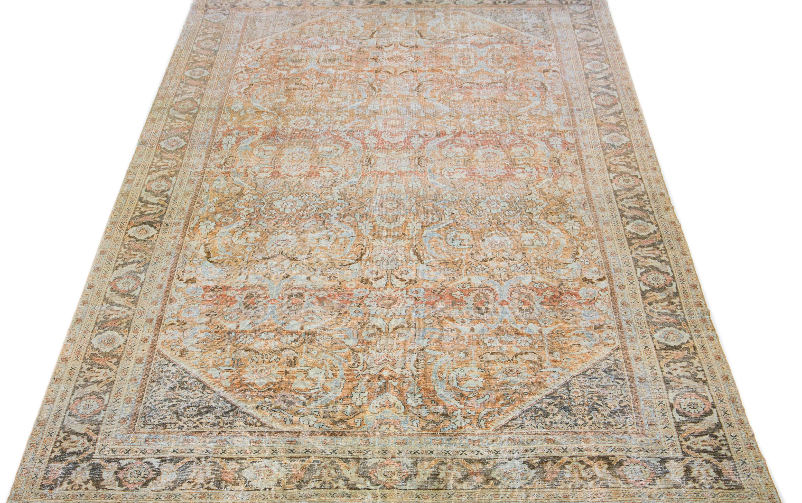 This hand-knotted mahal wool rug from the 1920s showcases a main orange/rust field, complemented by blue, peach, and brown hues in a traditional Allover floral motif.

This rug measures 10'2 x 17'.