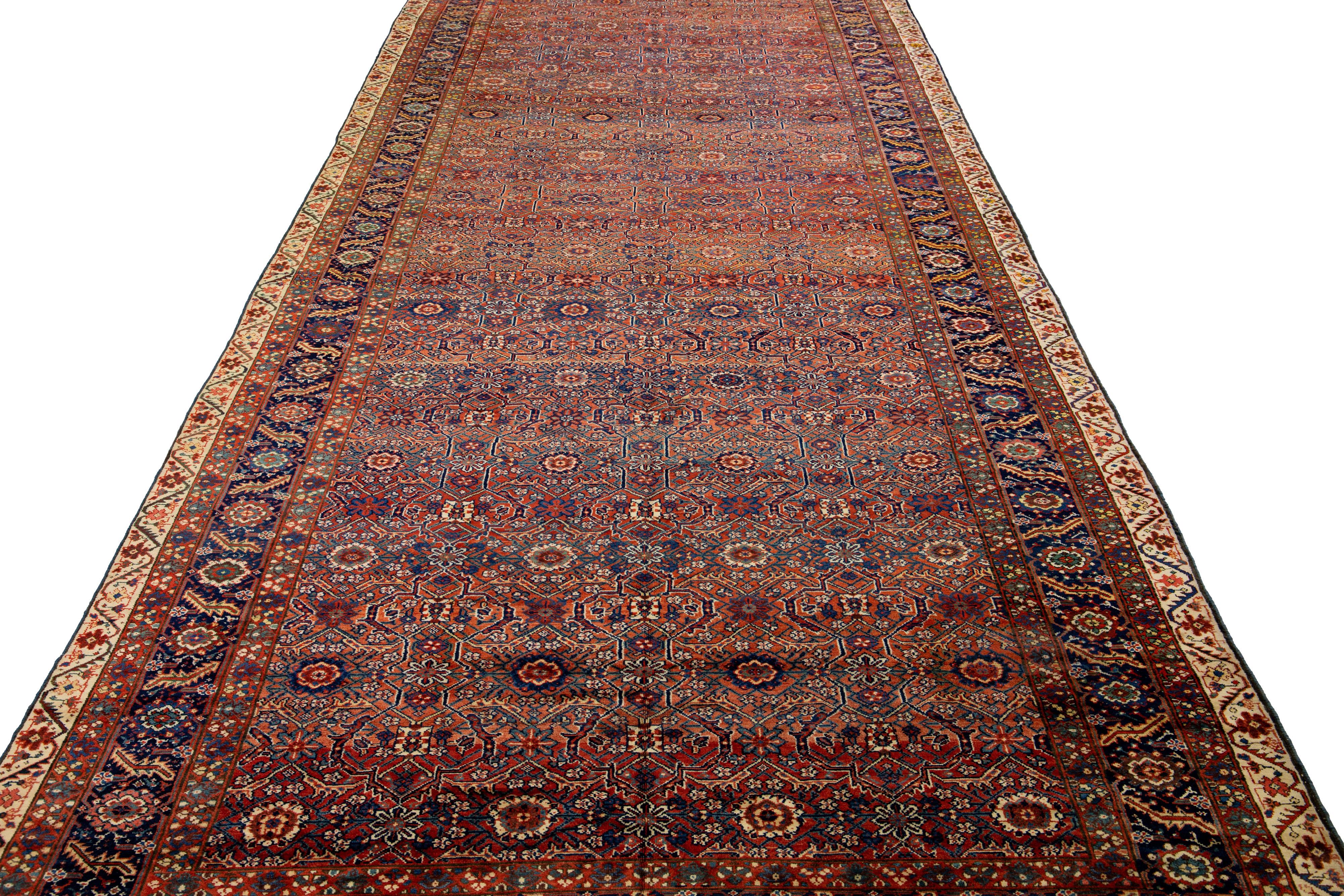 Beautiful antique Malayer hand-knotted wool rug with a rust color field. This Malayer piece has a designed frame with multicolor accents in a gorgeous all-over geometric pattern design.

This rug measures: 9'7