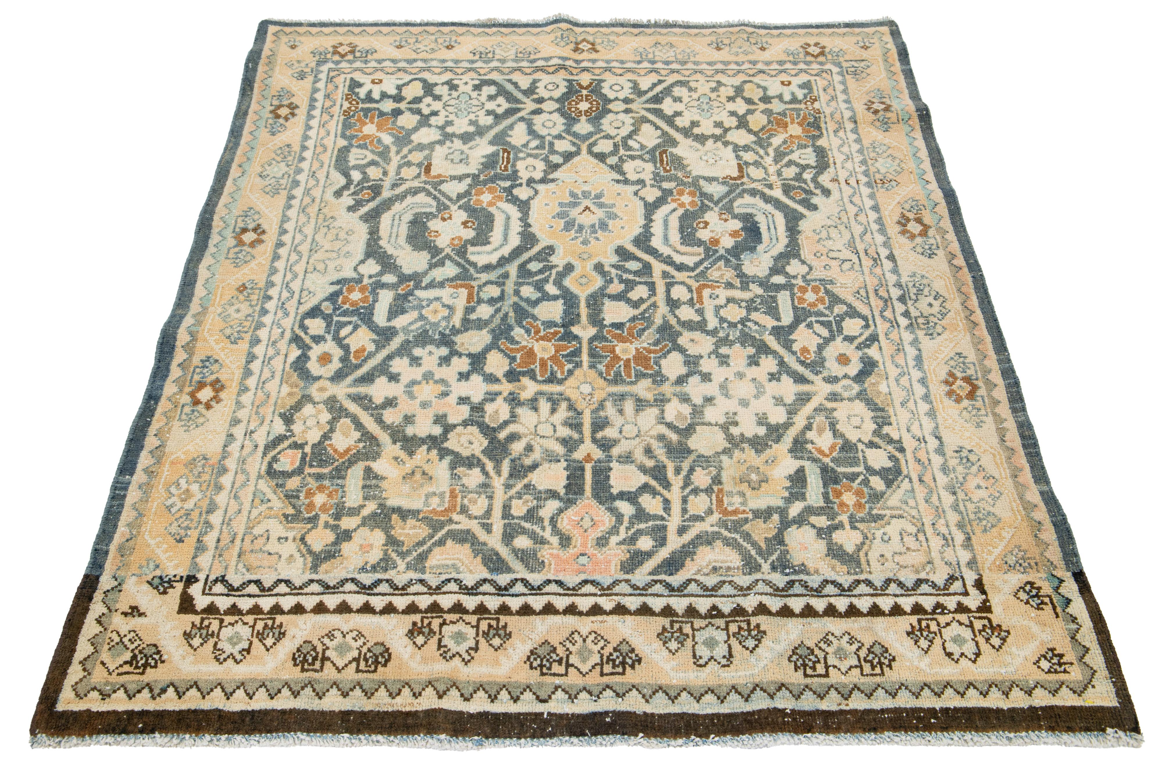 This is an antique Persian Malayer rug, hand-knotted with wool. It features a timeless classical pattern with a beautiful blue field adorned with beige highlights.

This rug measures 4'5