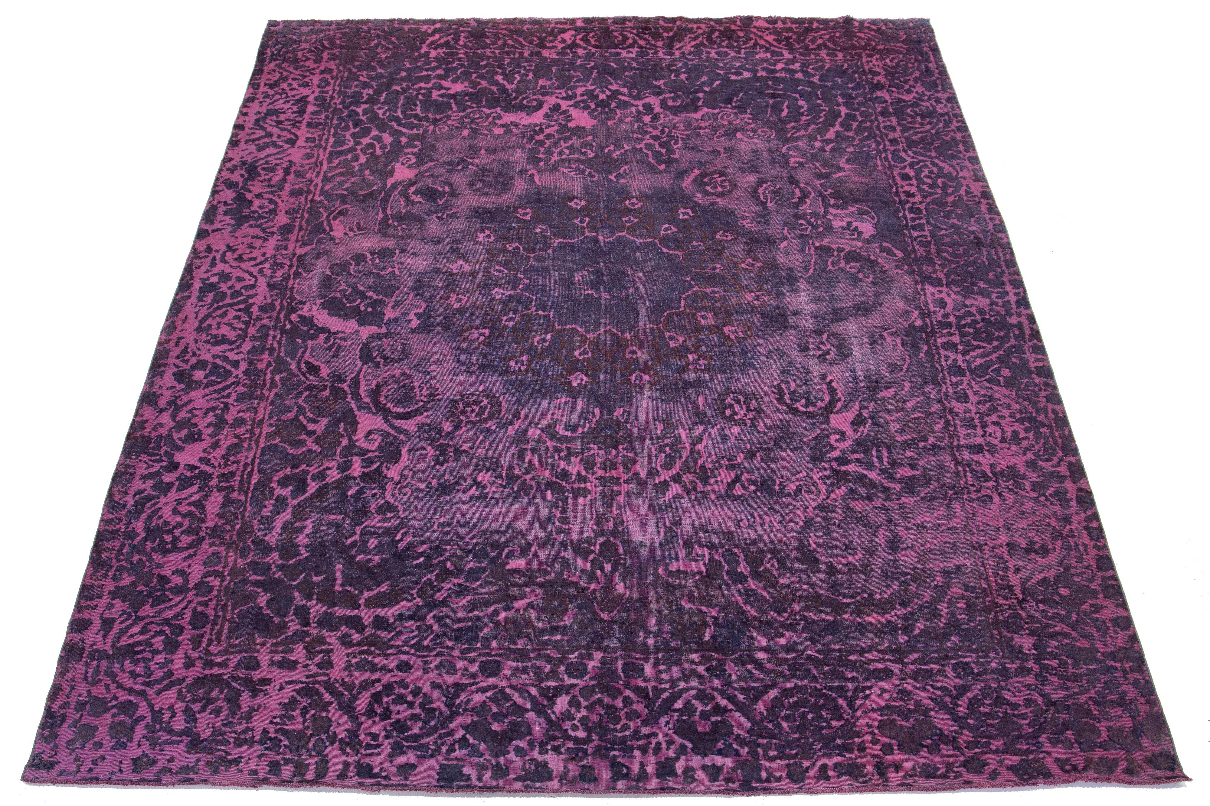 This antique purple Persian wool rug showcases a beautiful rosette design with blue and brown accents.

This rug measures 9'3'' x 13'1