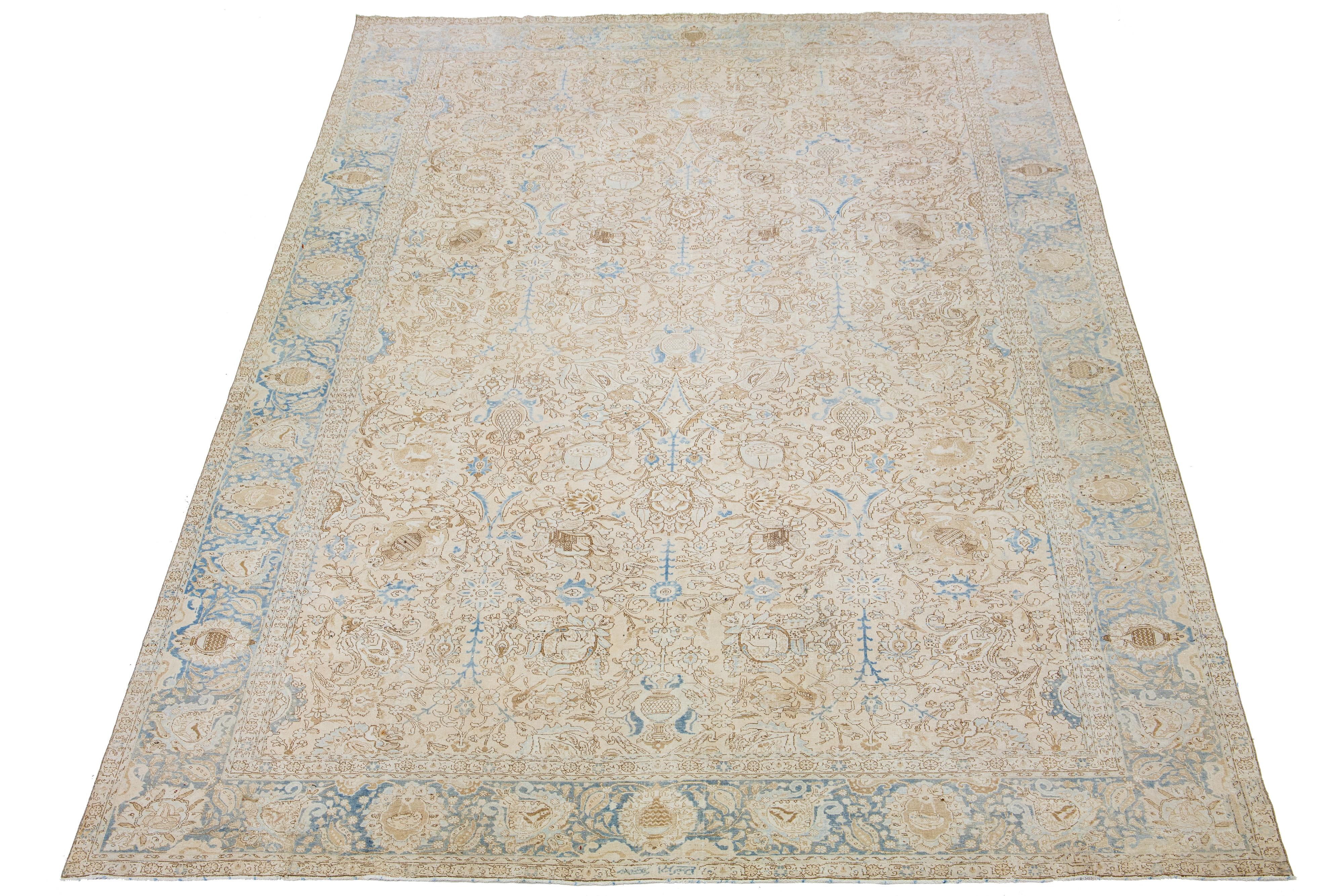 This handcrafted Persian Tabriz wool rug showcases a traditional floral pattern. The contrast between the beige backdrop emphasizes the brown and blue floral design.

This rug measures 11'1