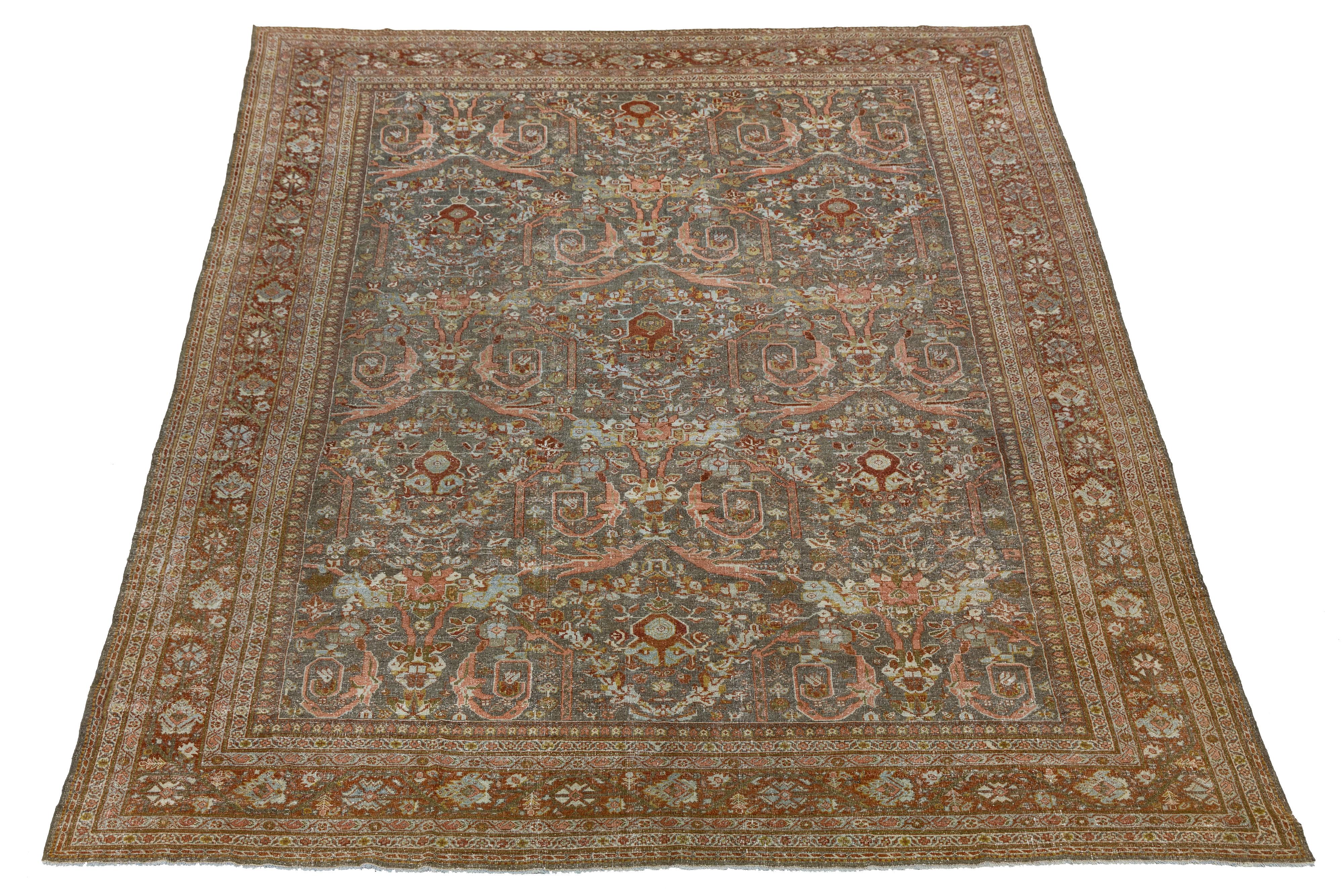A Persian Mahal from the 20th century, this handwoven wool rug exemplifies the refined village weaving traditions of the Mahallat region. The spacious field is adorned with an allover botanical lattice of stylized palmettes, floral sprays, and