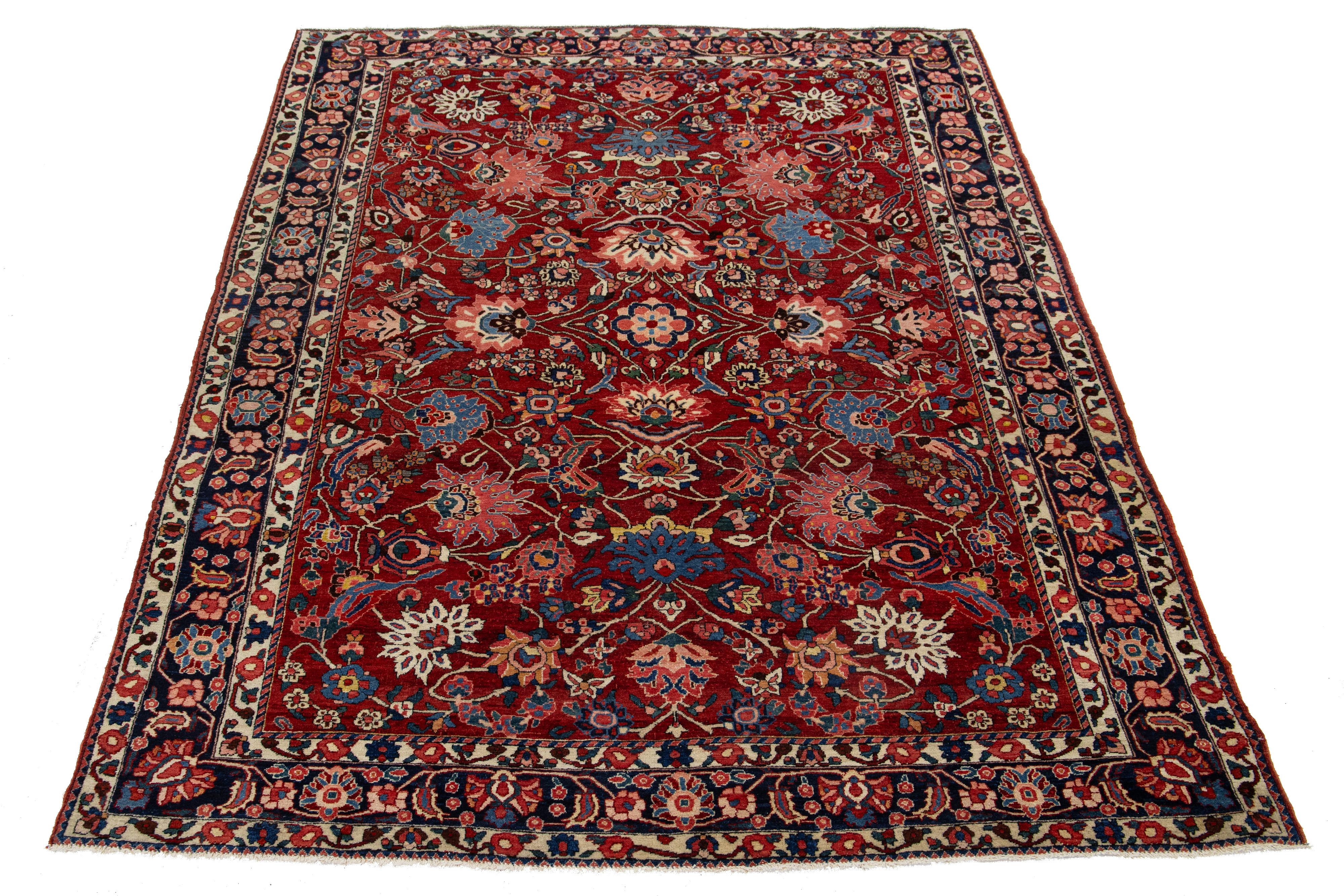 This is a beautiful, hand-knotted Antique Mahal wool rug with a red field. This Persian rug features a floral motif adorned with blue, pink, and green hues.

This rug measures 6'10'' x 10'.
     