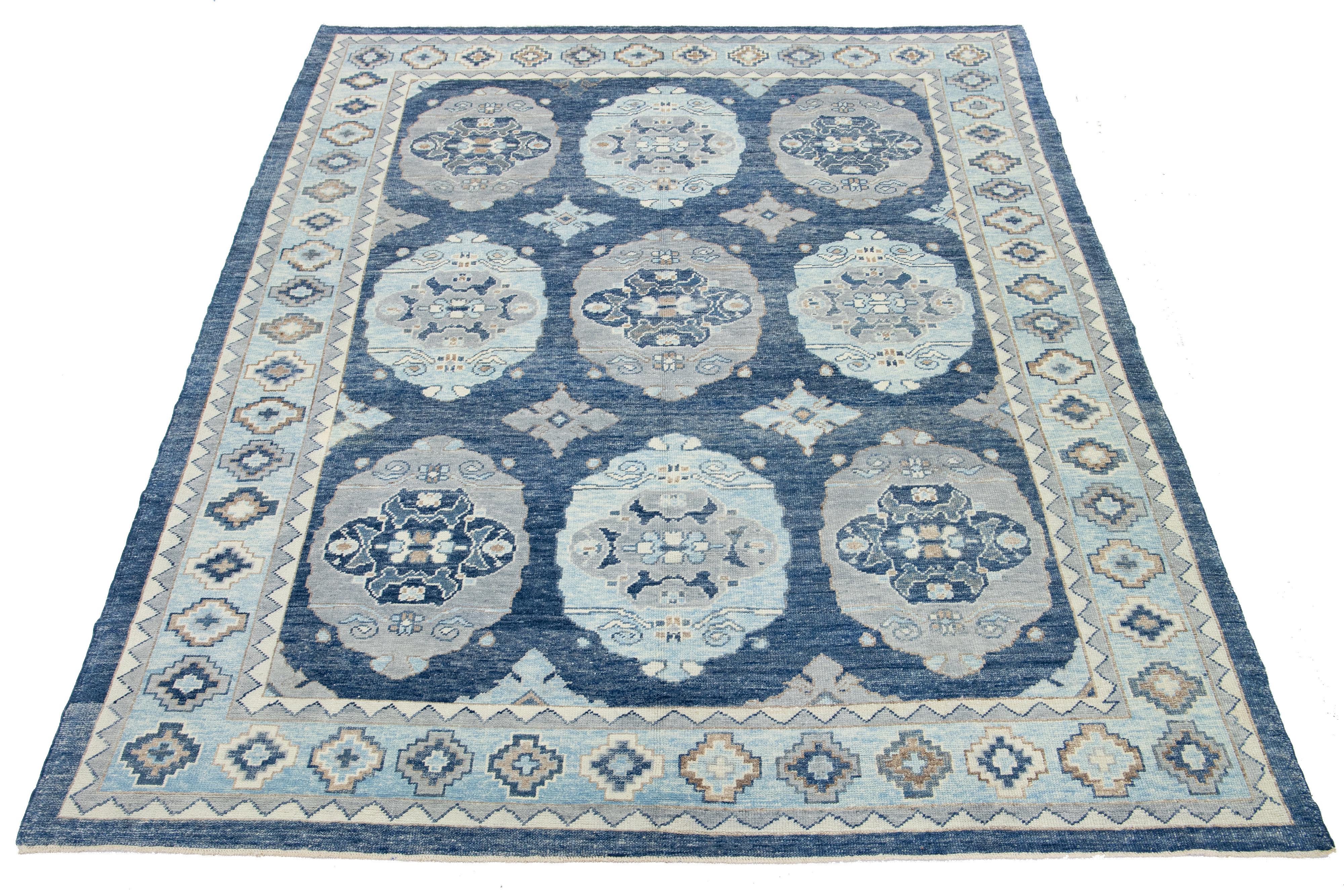 This stunning hand-knotted wool rug features a bold blue base with a captivating gray and ivory pattern, making it the perfect complement to any decor.

This rug measures 9'1