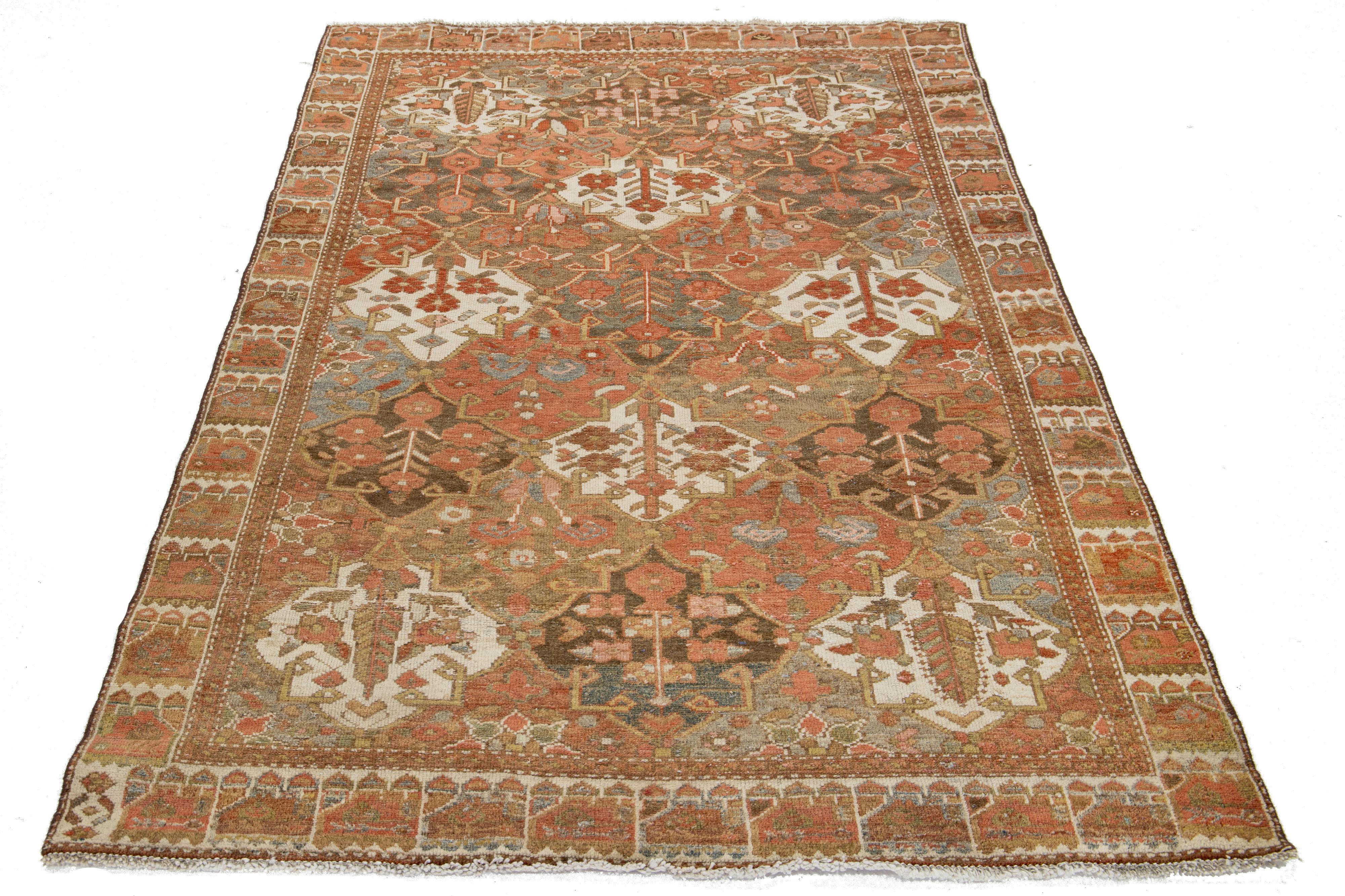 This stunning hand-knotted wool rug showcases a classic Persian design with rust and blue color fields and gray, brown, and beige accents.

This rug measures 4'3