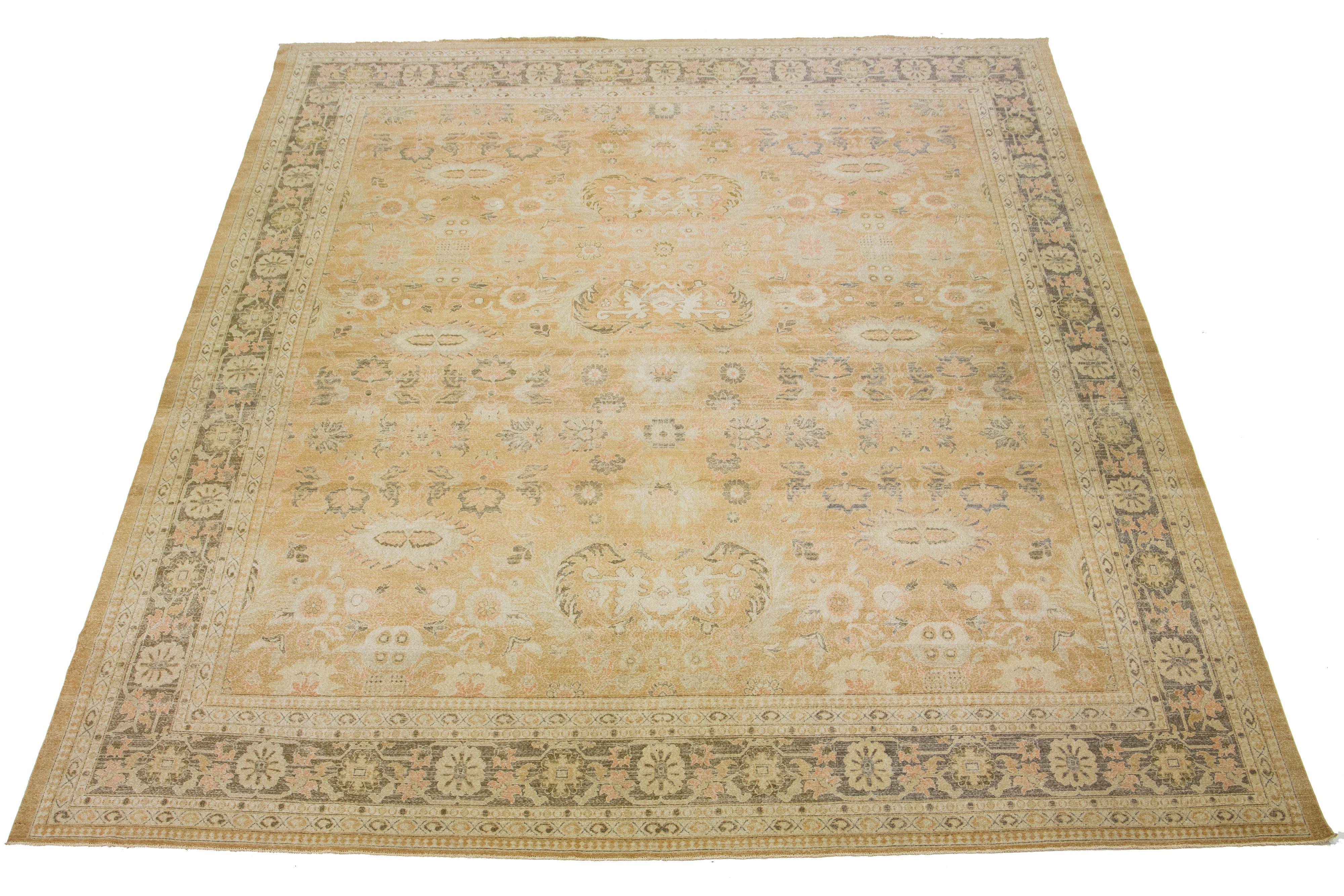 Beautiful Turkish Sivas hand-knotted wool rug with a tan-brown field. This piece has a gray-designed frame and accents in a gorgeous allover classic floral design with green, beige, and terracotta hues. 

This rug measures 13'6