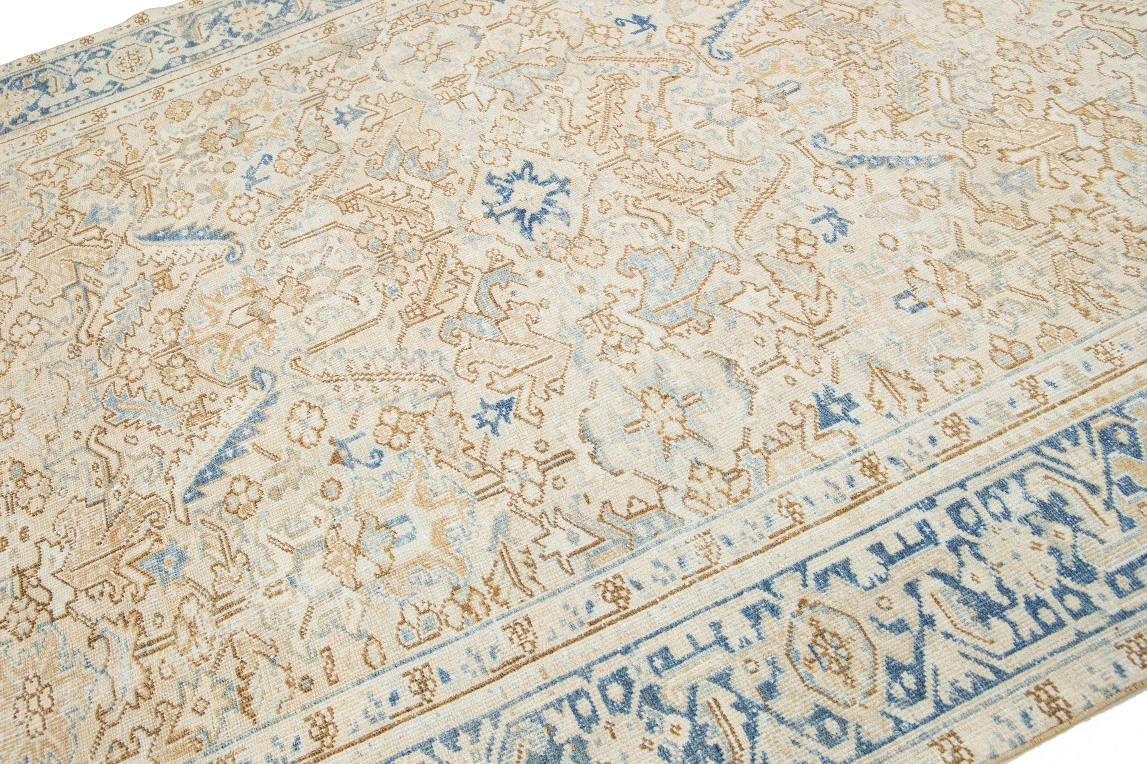 This antique Persian Heriz rug is crafted with hand-knotted wool. The beige-colored field features a captivating allover pattern embellished with shades of blue and brown.

This rug measures 7'3