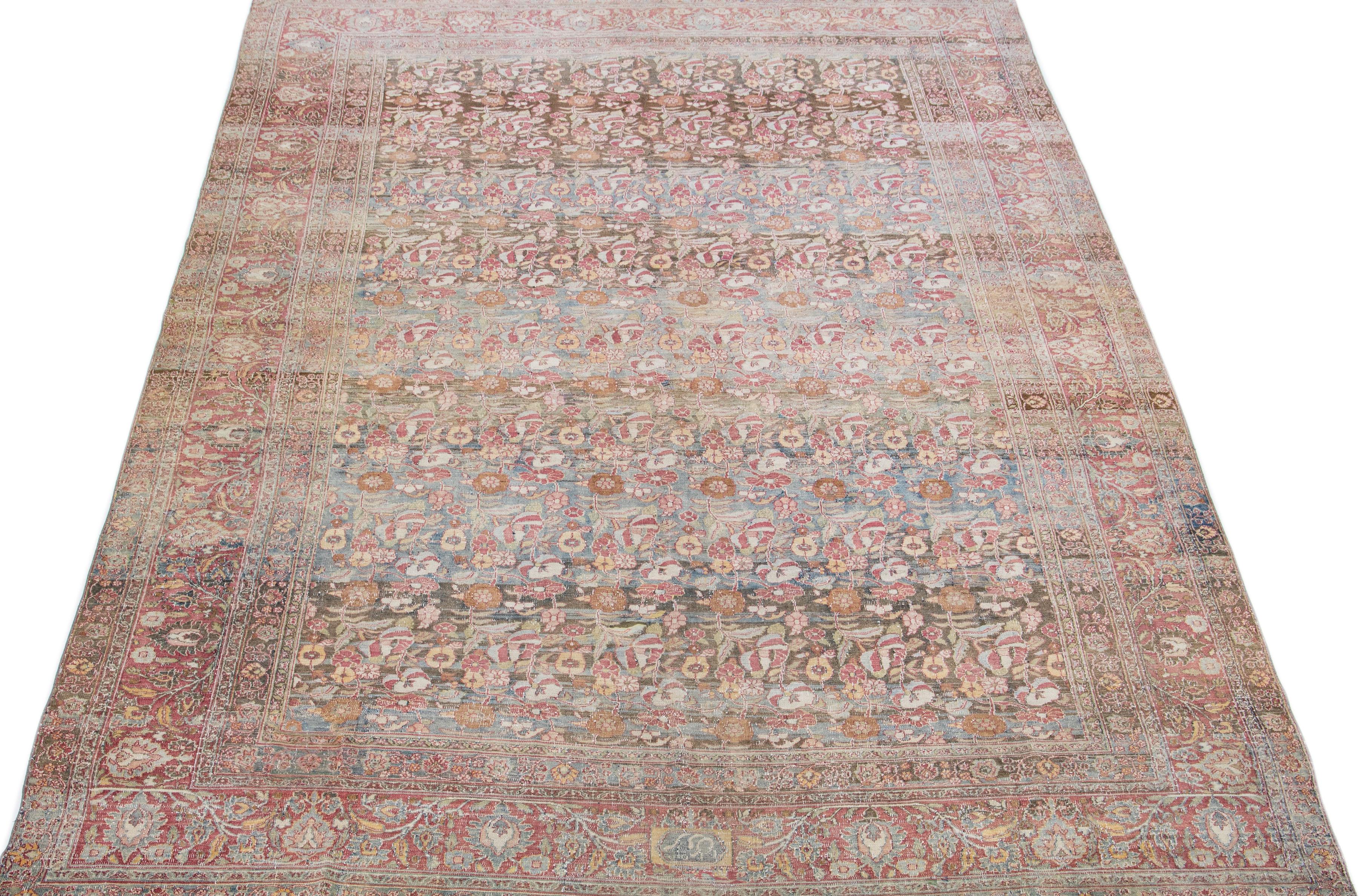Beautiful hand-knotted antique oversize mahal wool rug with a blue field. This Persian rug has red, brown, and blue accent colors with an all-over floral design. 

This rug measures 9'3