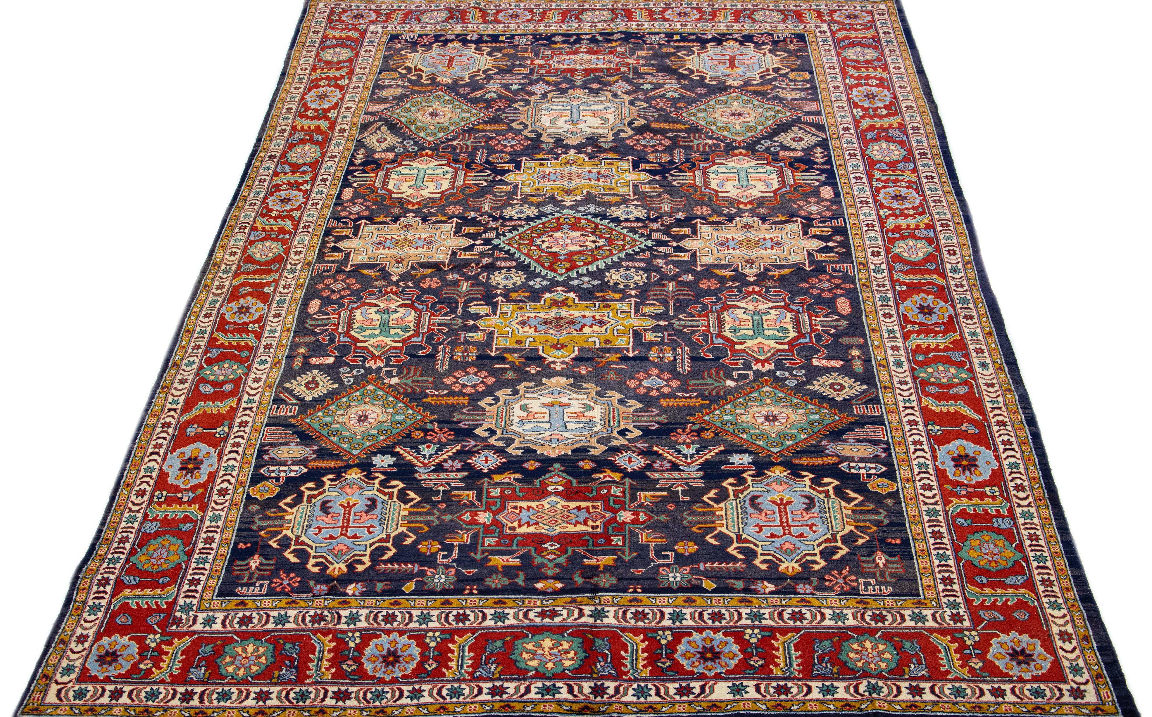Beautiful vintage Heriz hand knotted wool rug with a blue field. This Persian rug has multi-color accents and a gorgeous all-over geometric floral medallion design.

This rug measures 6'11