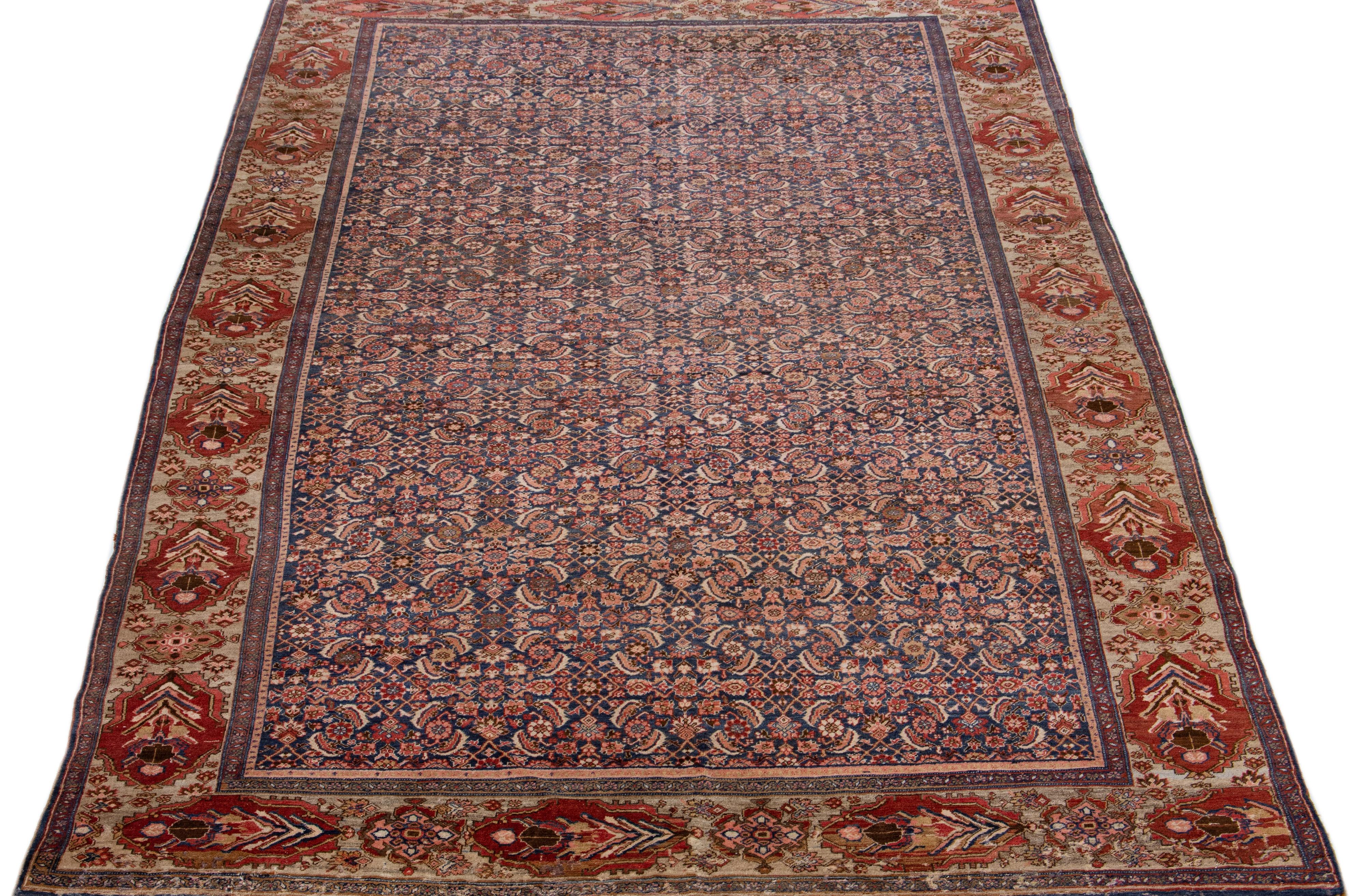 Beautiful antique Bidjar hand-knotted wool rug with a blue color field. This Persian rug has rust, green, and pink accents colors in a gorgeous traditional floral design.

This rug measures 9' x 13'8