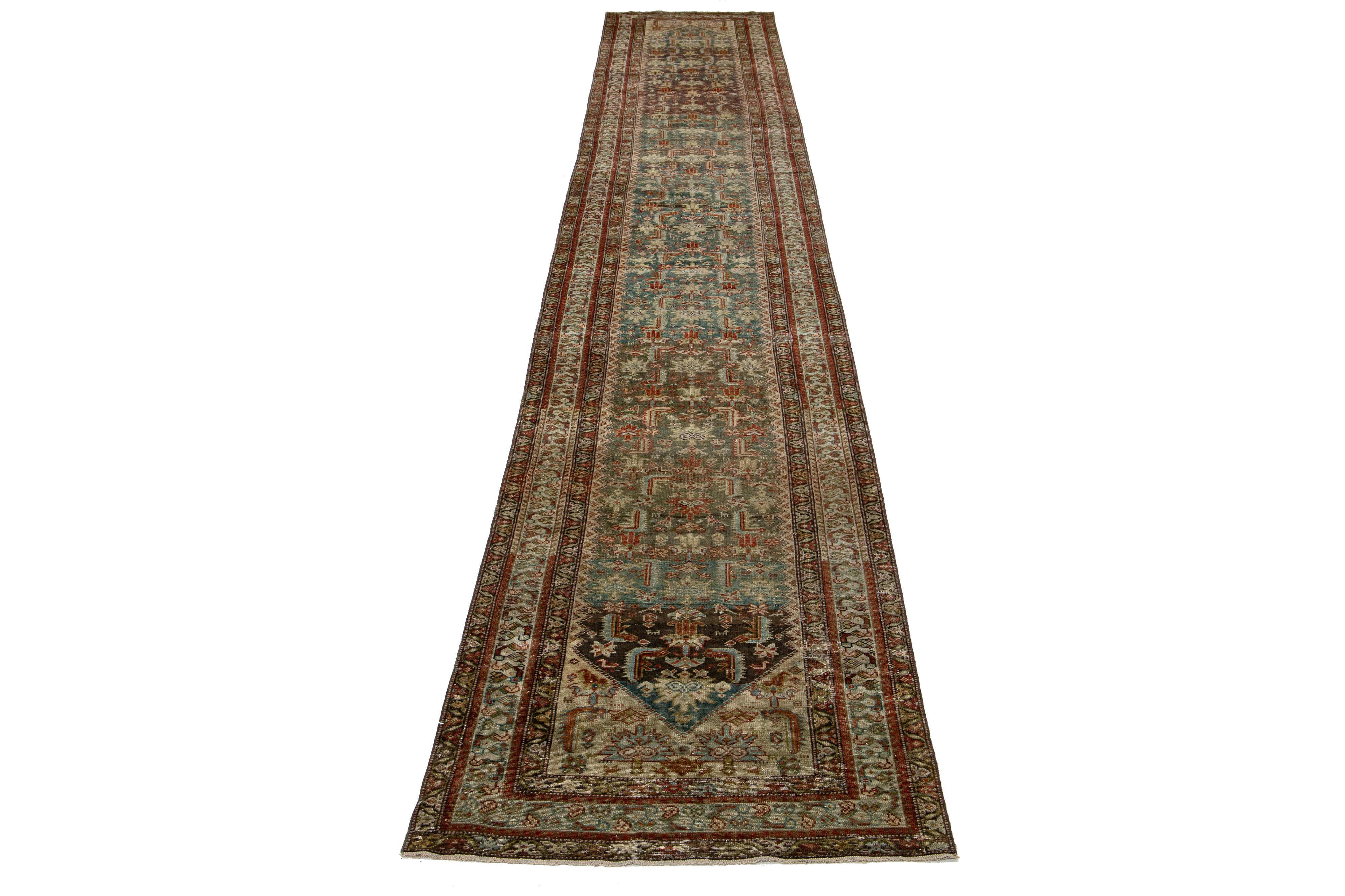The Persian Malayer wool rug exudes an antique elegance with its hand-knotted wool construction. Its blue field is beautifully decorated with a floral pattern highlighted by rust, brown, and golden accents.

This rug measures 3'2