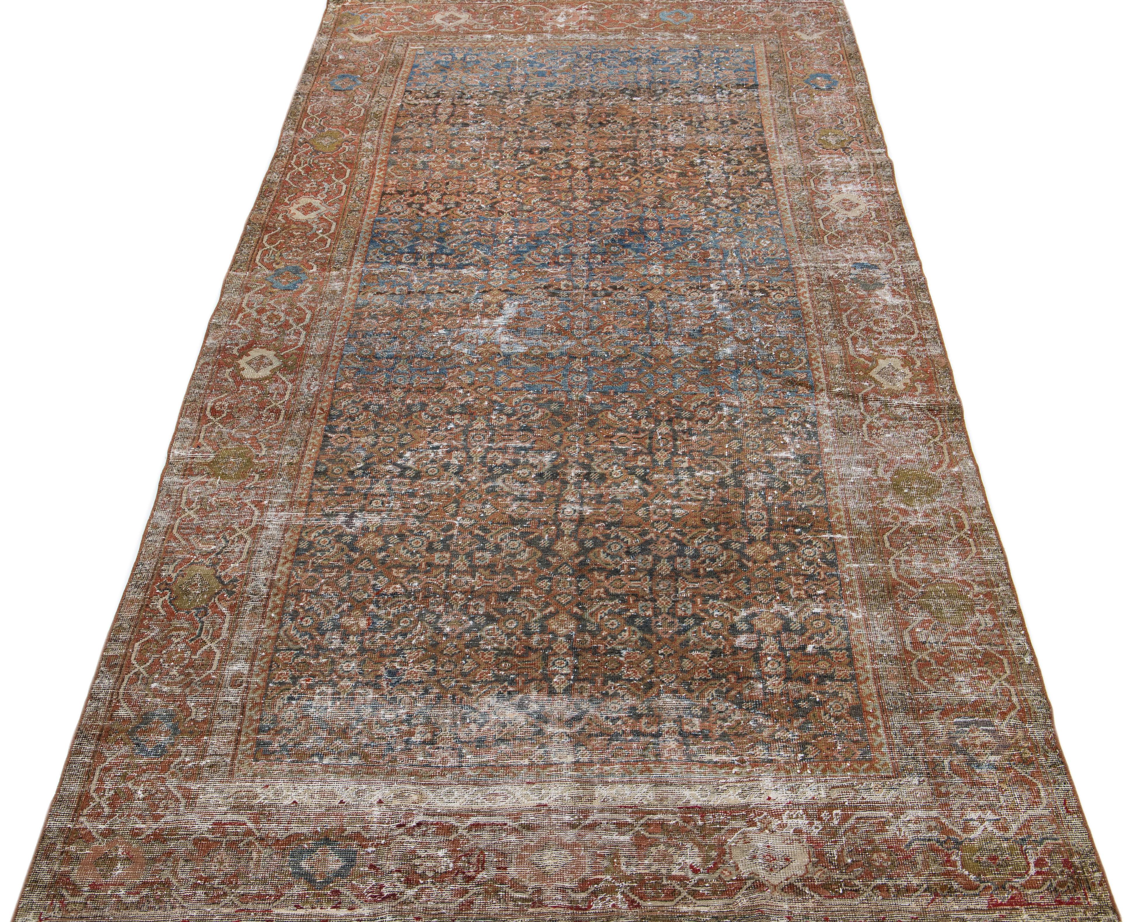 Beautiful hand-knotted antique mahal wool rug with a blue color field. This Persian rug has rust and brown accent colors in an all-over floral design.

This rug measures: 4' 11