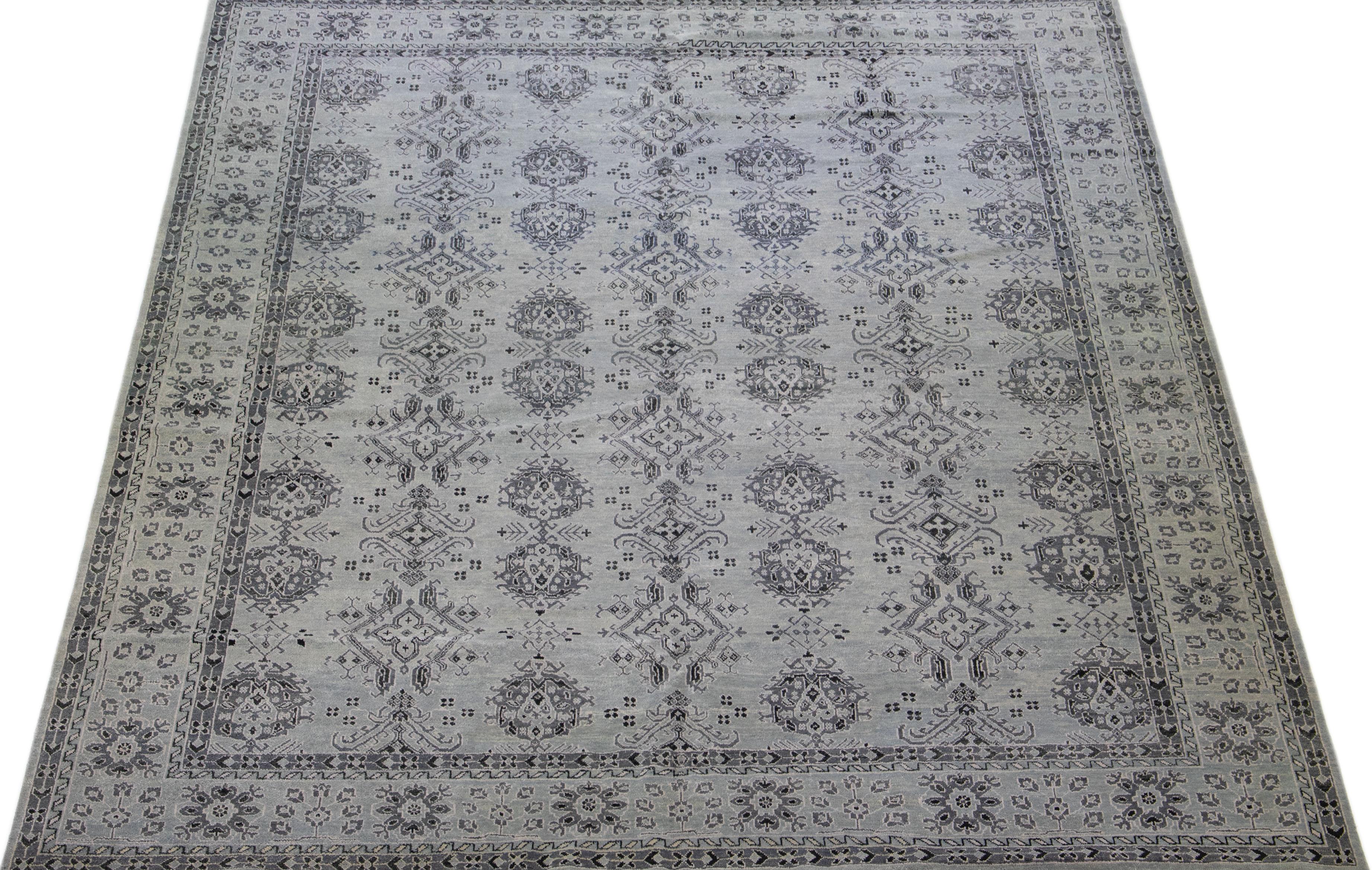 Beautiful modern Oushak hand-knotted wool rug with a light gray color field. This Piece has dark grey accent colors in a gorgeous all-over pattern design.

This rug measures: 12' x 14'9