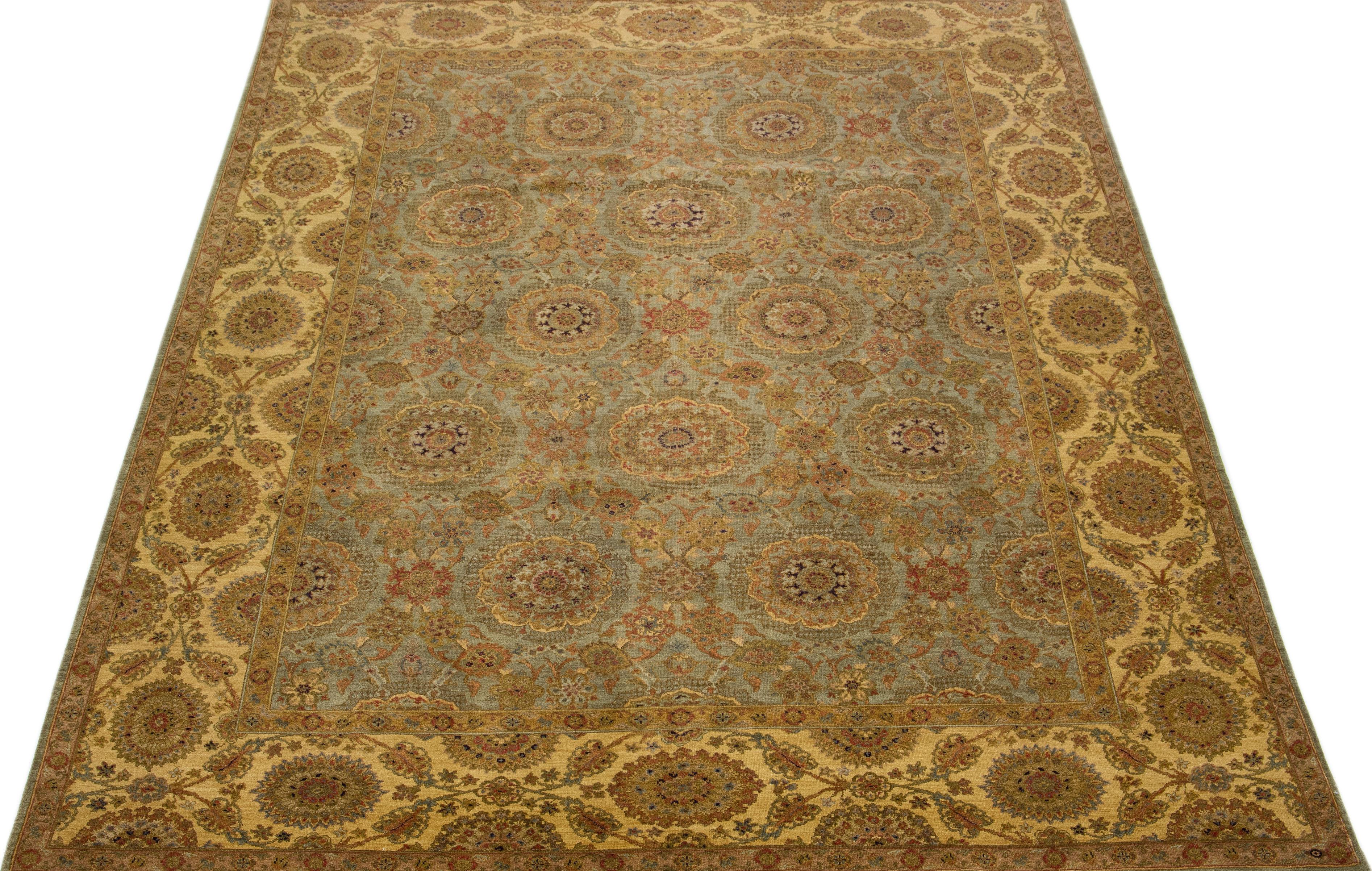 Beautiful antique Indian hand-knotted wool rug with a gray color field. This piece has a gorgeous allover floral design in beige, gray, and goldenrod colors.

This rug measures 9'1