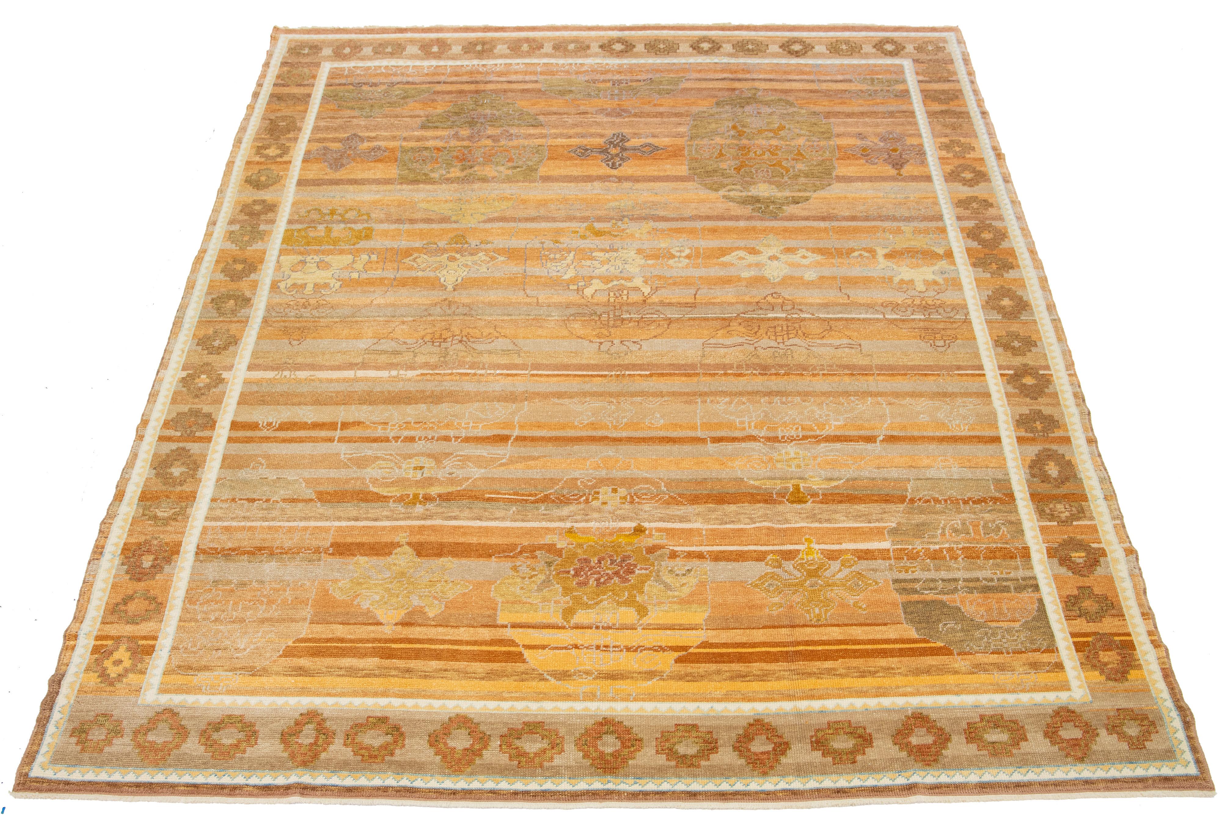 Beautiful contemporary Turkish Oushak rug, made of hand-knotted wool, featuring an orange field with accents of brown and gold in an all-over geometric design.

This rug measures 9'4” x 13'.

Our rugs are professionally cleaned before shipping.