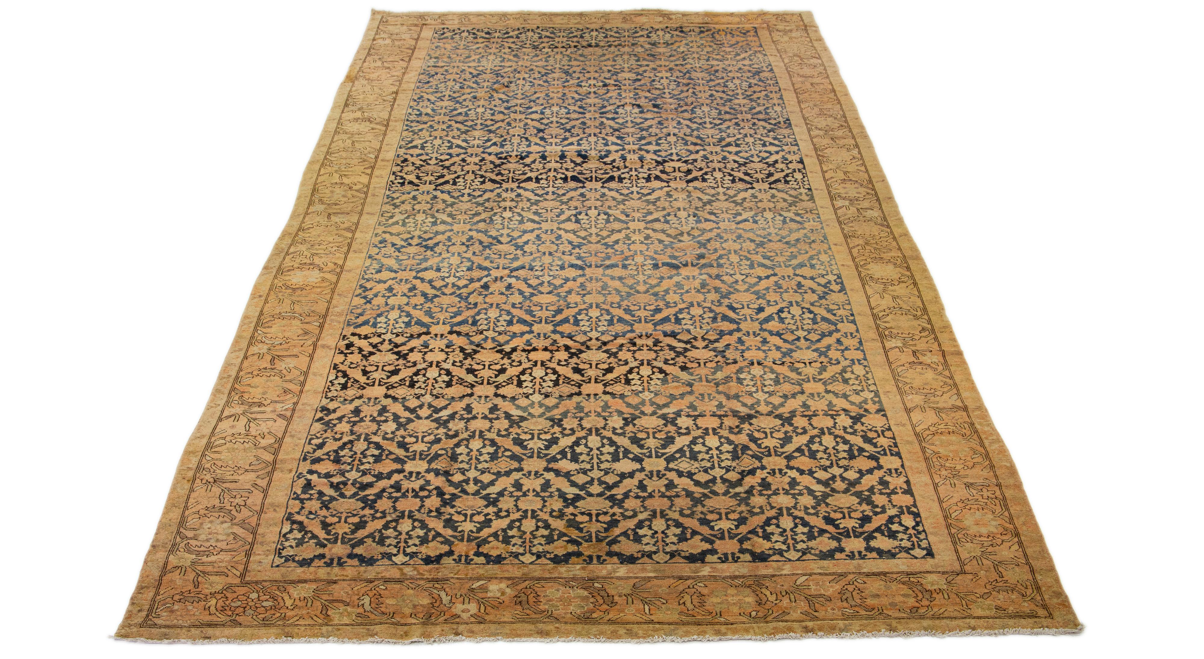 This exceptional, antique Persian Malayer rug is handcrafted from meticulously woven wool. The display features a calm navy blue at its base, embellished with tan highlights in an impressively intricate all-over classical pattern.

This rug measures