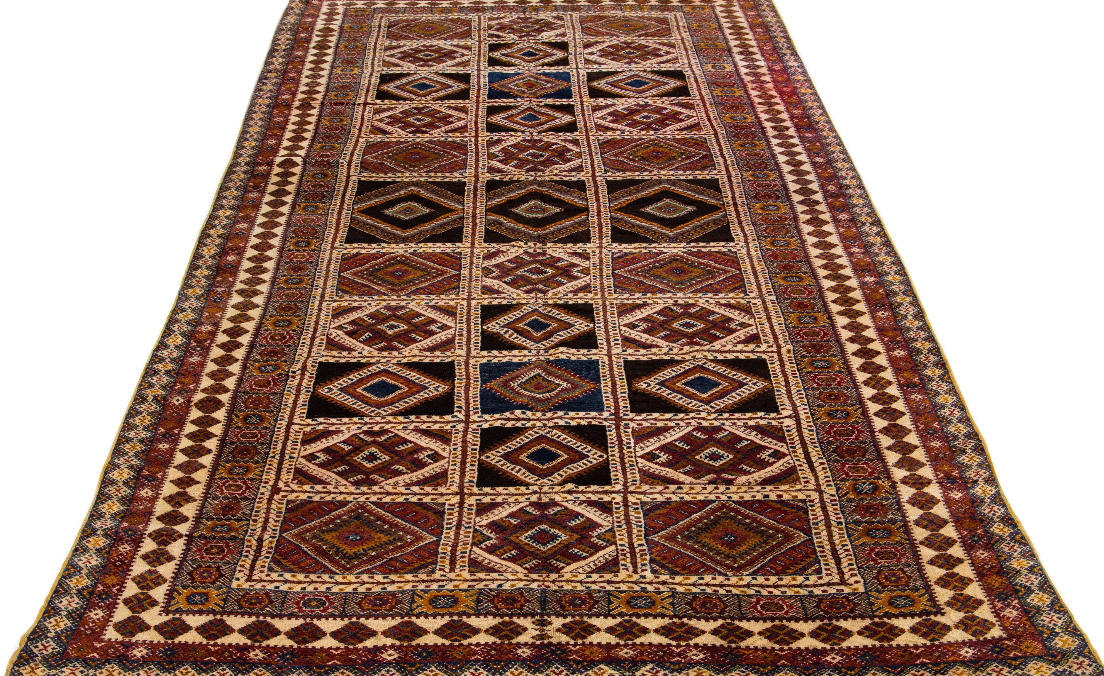 Beautiful Vintage oversize  Moroccan hand-knotted wool rug with a blue, beige, and red color field in an all-over geometric tribal design.

This rug measures: 8' x 16'1