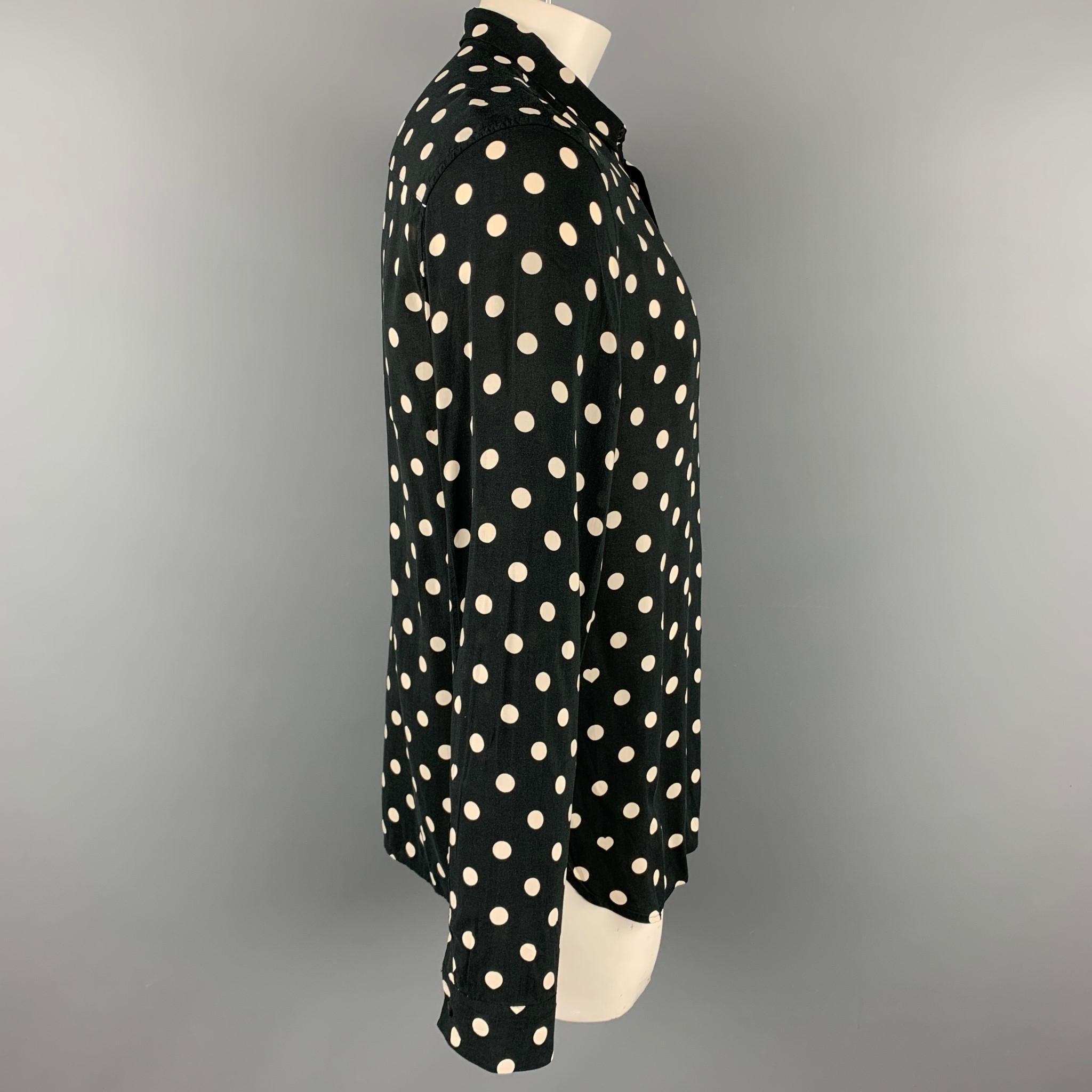 ALLSAINTS long sleeve shirt comes in a black & white polka dot viscose featuring a button up style and a spread collar.

Good Pre-Owned Condition.
Marked: XL

Measurements:

Shoulder: 19 in.
Chest: 44 in.
Sleeve: 28 in.
Length: 30.5 in. 