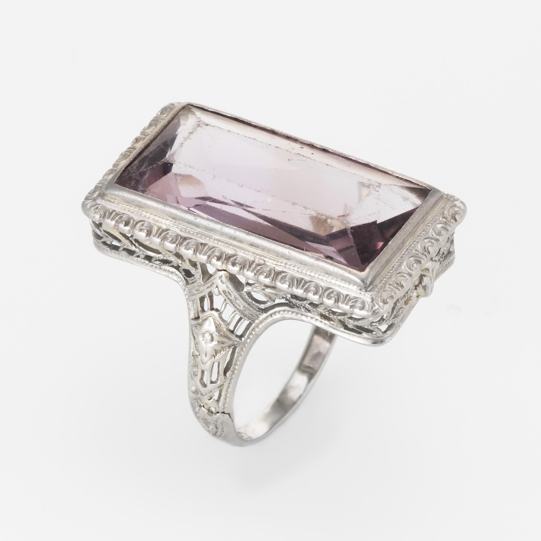 Finely detailed vintage Art Deco era ring (circa 1920s to 1930s), crafted in 18 karat white gold. 

Centrally mounted rectangular cut amethyst measures 19mm x 10mm (estimated at 11 carats). Note: light surface abrasions to the amethyst. 

Lacy