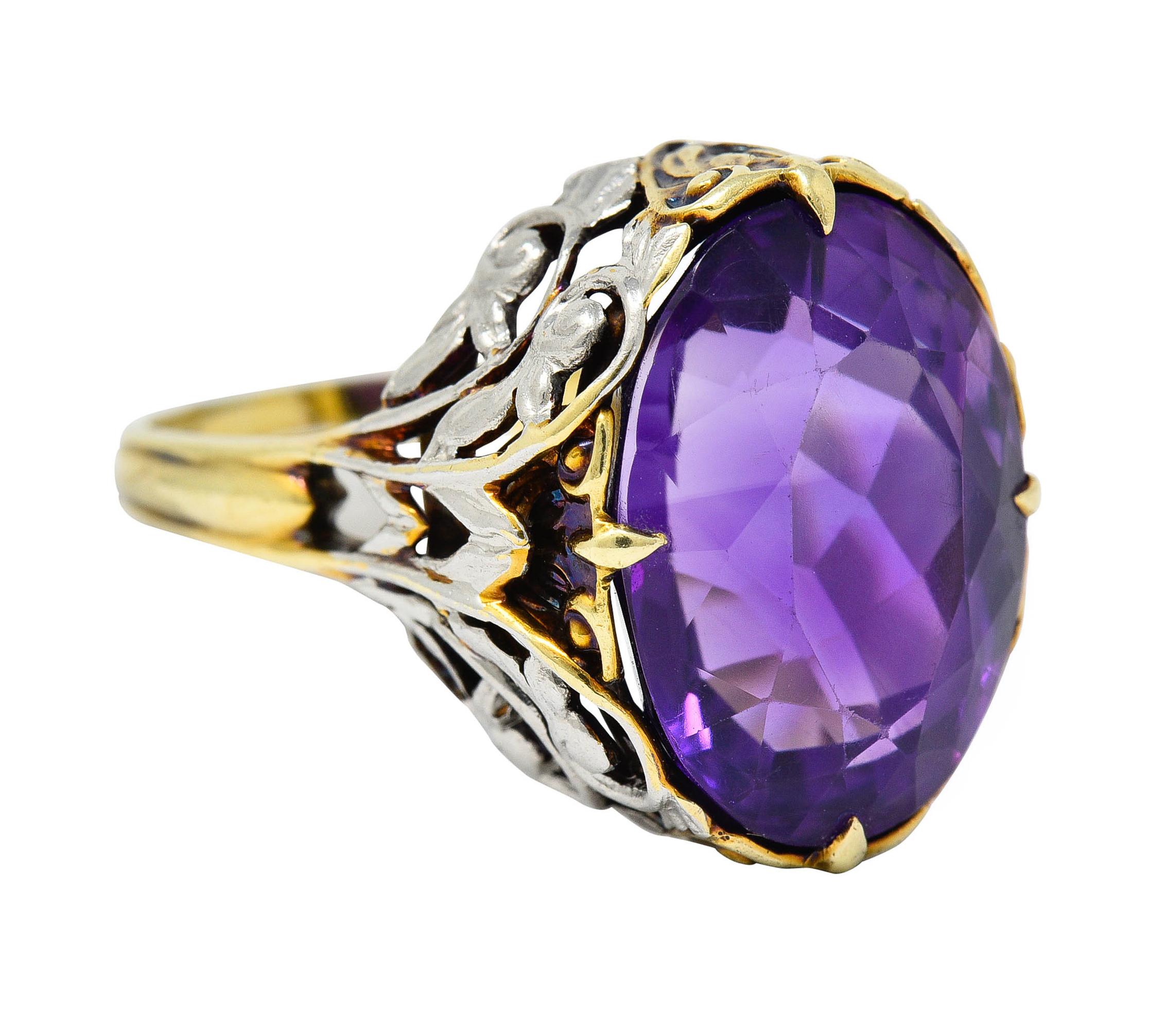 Centering a mixed oval cut amethyst measuring approximately 15.5 x 11.5 mm - saturated purple

With a pierced gallery comprised of scrolling foliate motifs accented by white gold appliquè

Stamped 14K for 14 karat gold

With maker's mark for