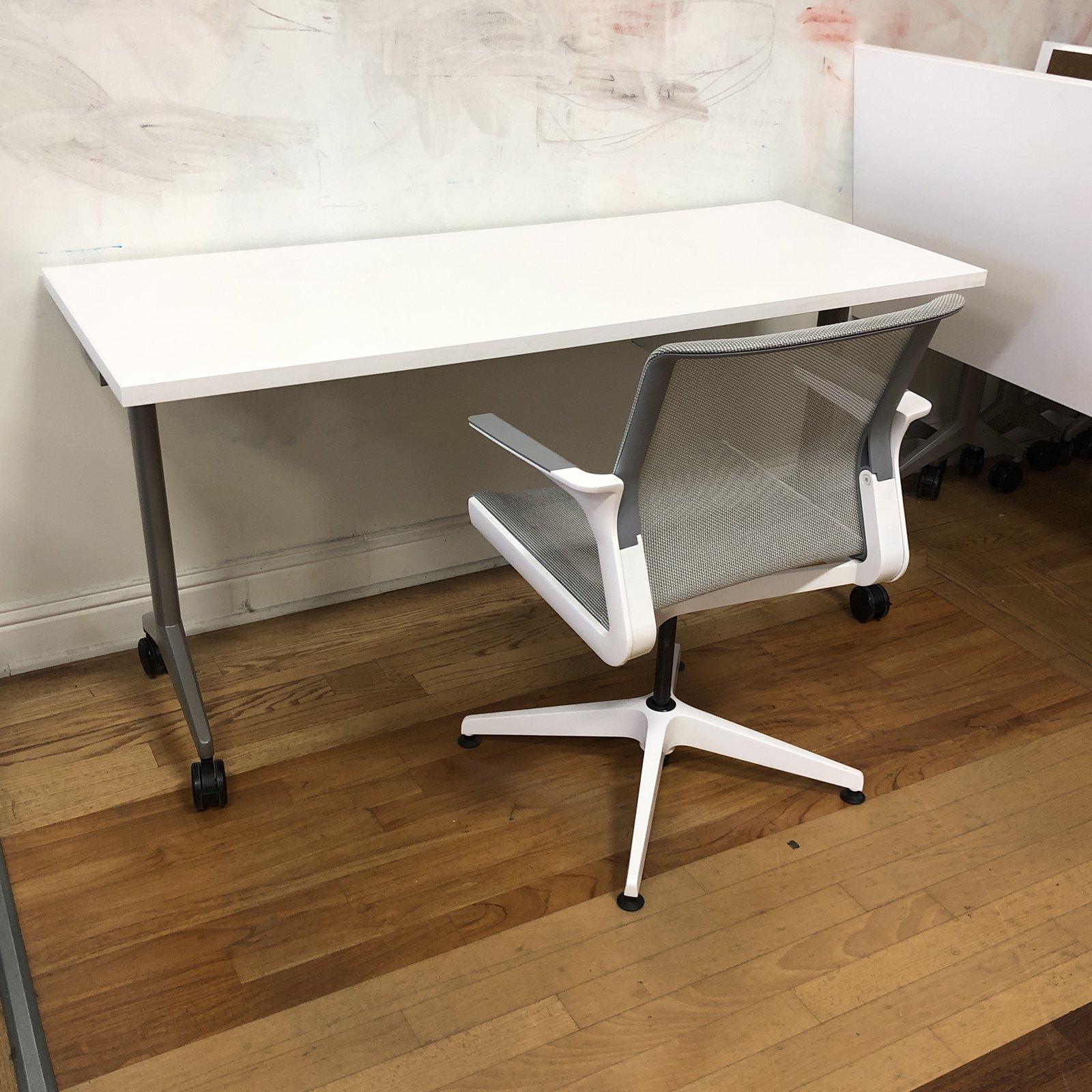 Aware folding table by Allsteel Furniture. The top is a frosty white laminate with a silver finish base. Has four black casters to make the table mobile. A mobile solution for flexible learning environments, hard-working training rooms, or