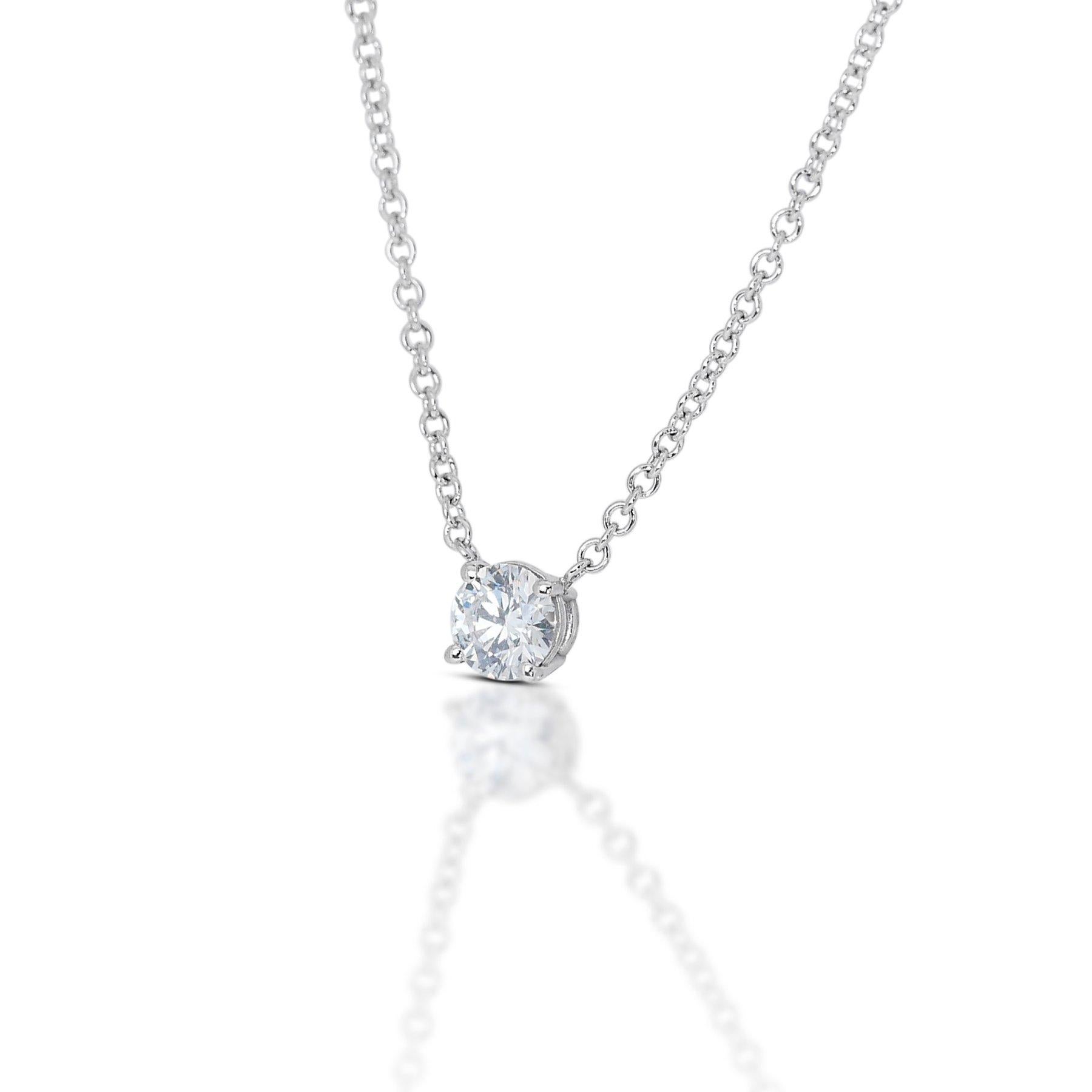 Capture the spotlight with this breathtaking necklace, a delicate dance of light around a captivating 0.32 carat round diamond. Its coveted D color sparkles with pure brilliance, amplified by the exceptional SI1 clarity that guarantees minimal