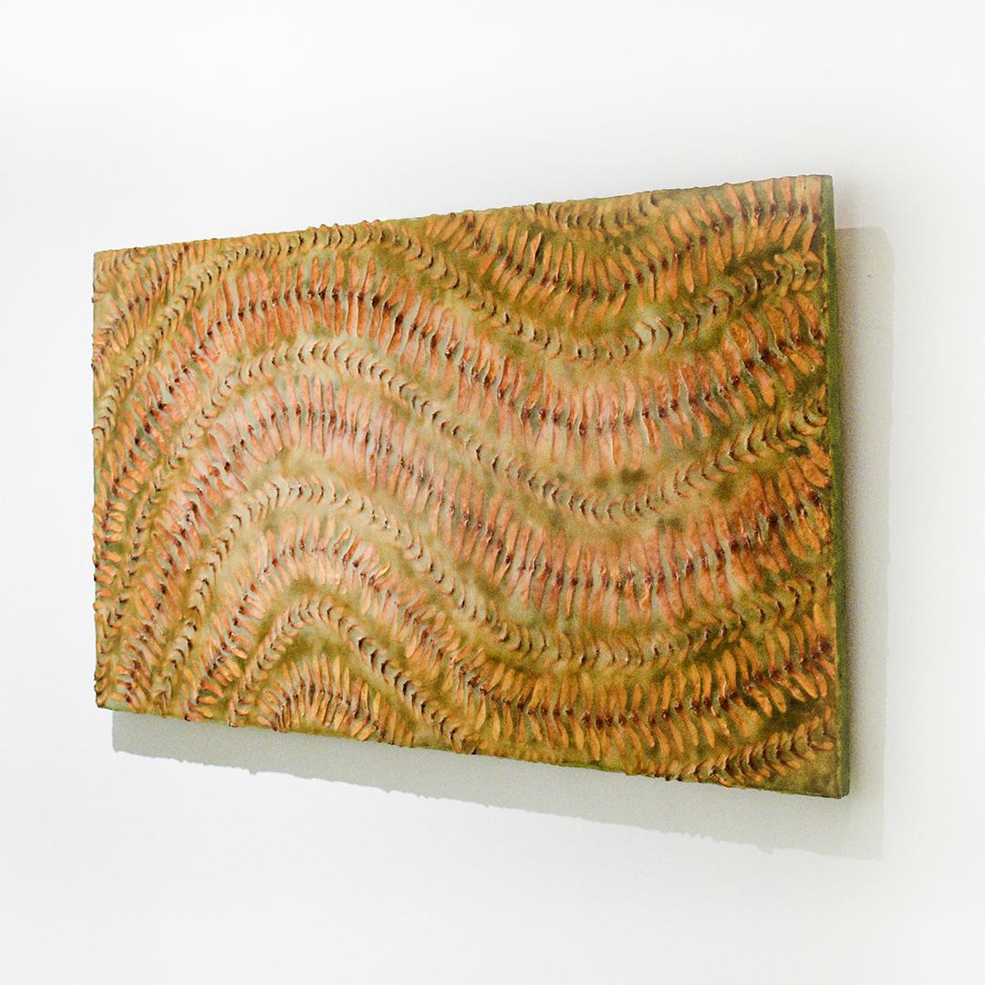 Abstract painting with orange and sienna colored plant material arranged on green encaustic 

