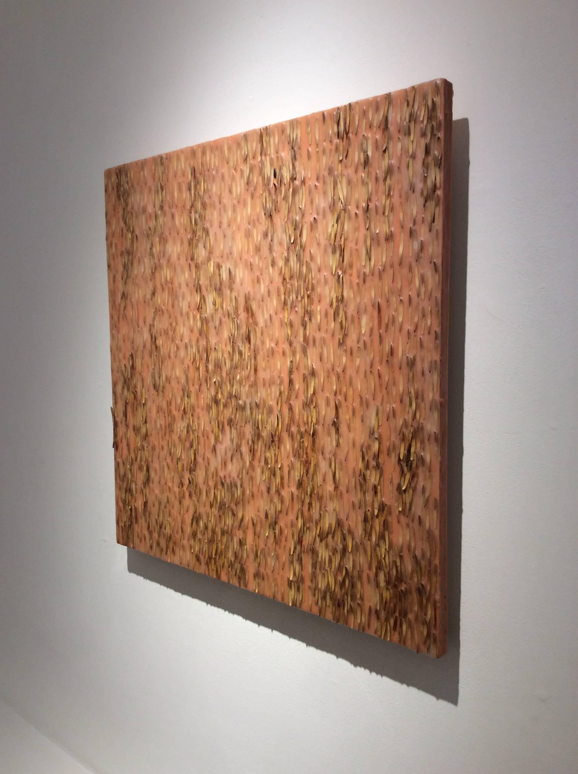 Abstract encaustic painting with dark brown and beige ash keys against a light orange, peach background
24 x 24 x 1.5 inches 

This modern abstract encaustic painting by Allyson Levy is made with assorted beige and light brown ash keys encased in a