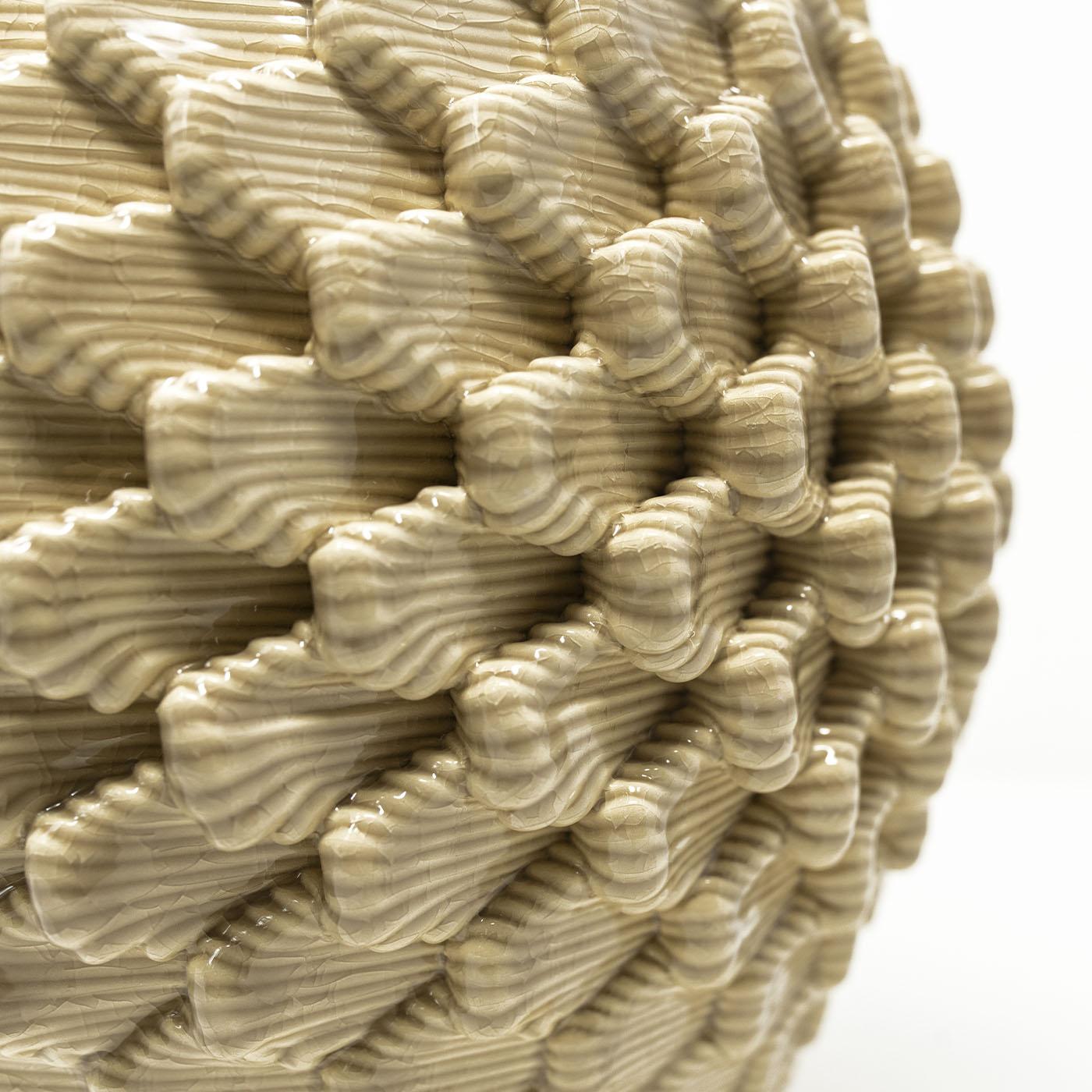 Alma, a 3D-printed vase, draws from the Caltagirone pine cone's shape, symbolizing vitality and eternity. Combining digital artistry, craftsmanship, and nature, it embodies Sicilian allure. Reflecting the fertility of the mind and novel ideas, Alma