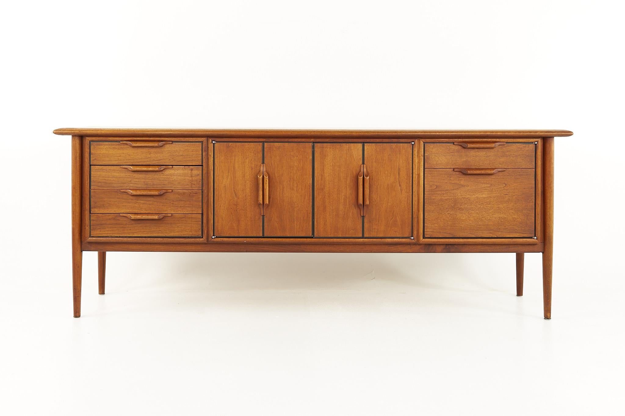 Alma Castilian Line Mid Century Walnut Credenza

This credenza measures: 77 wide x 21 deep x 28.5 inches high

All pieces of furniture can be had in what we call restored vintage condition. That means the piece is restored upon purchase so it’s free