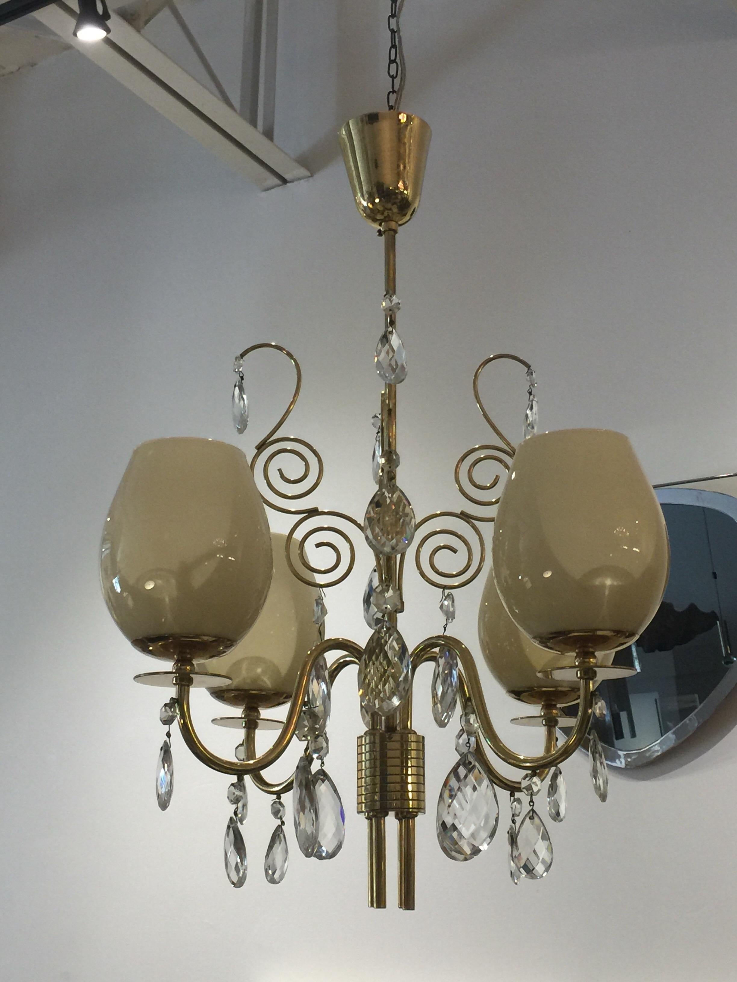 This 4-light chandelier by Almari Mauri of Finland, in brass, glass and faceted crystals. Beautiful vintage piece with a lovely patina on brass. Original canopy included.