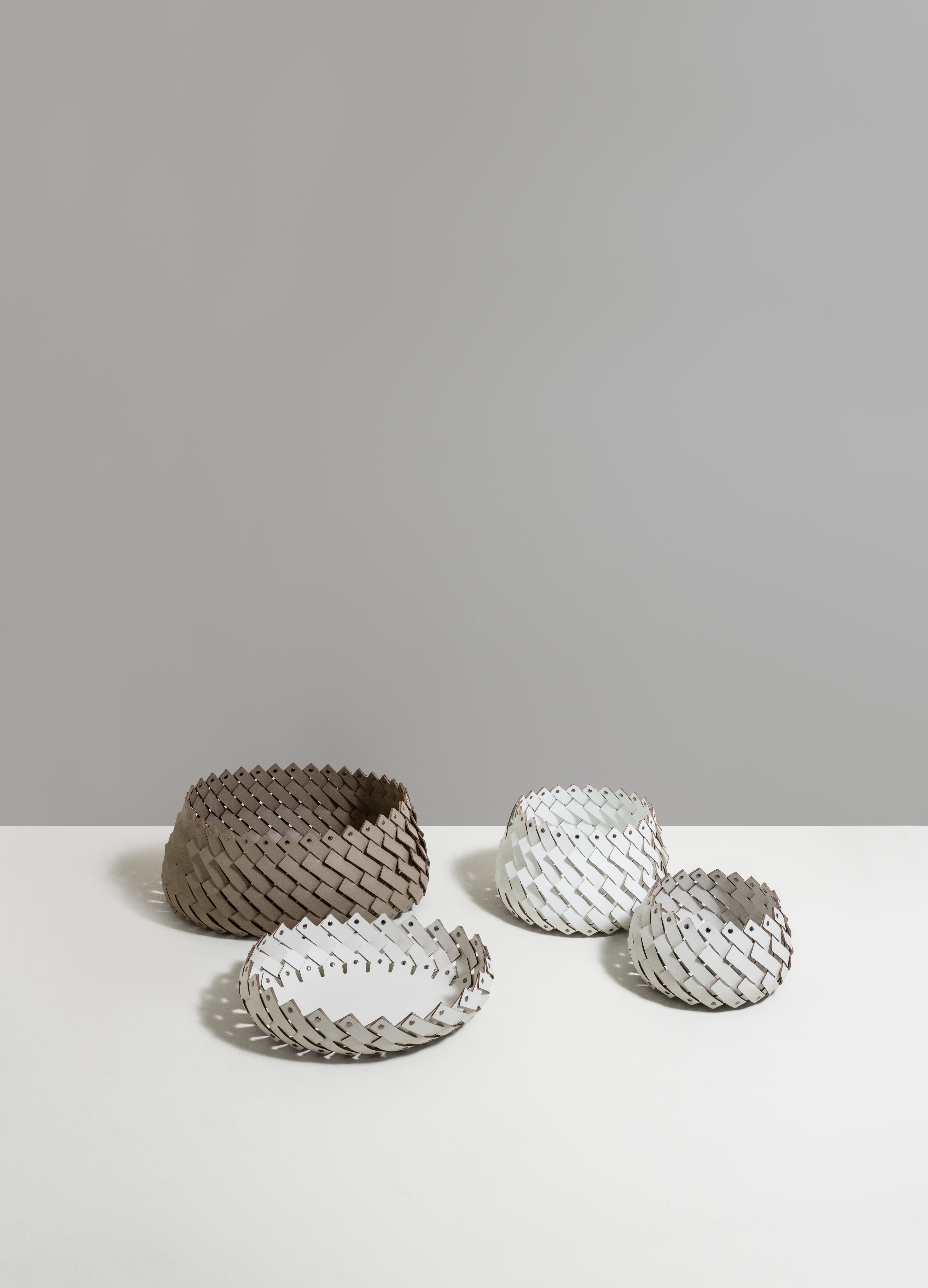 Part of the iconic Almeria collection by Pinetti, this basket in white eco-friendly leather has a low yet generous shape that will lend a unique texture to any interior. Entirely woven by hand, the strips form a diagonal design and are fixed on top