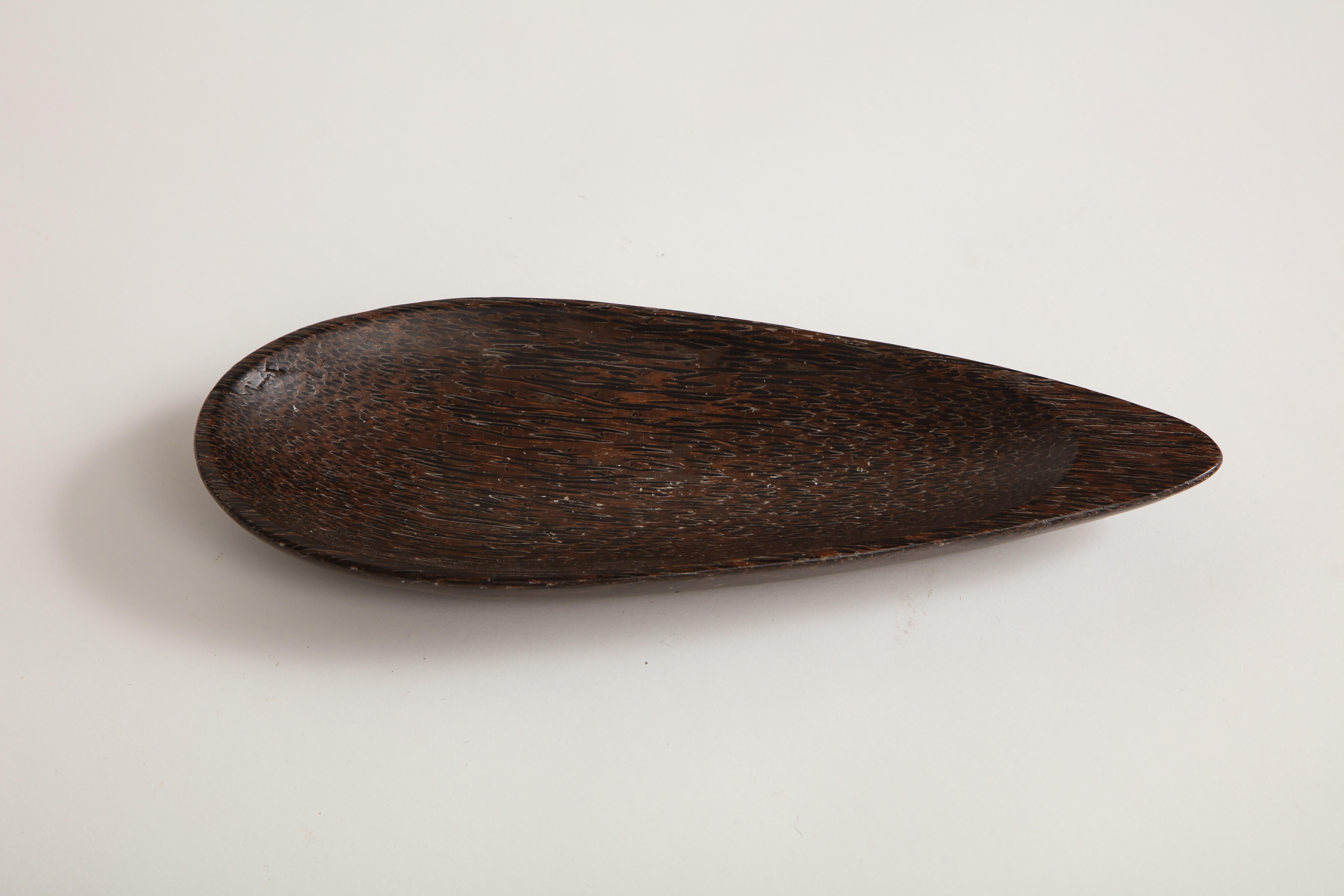 Dark palmwood almond shaped dish.

Solid wood. Lovely organic shape.