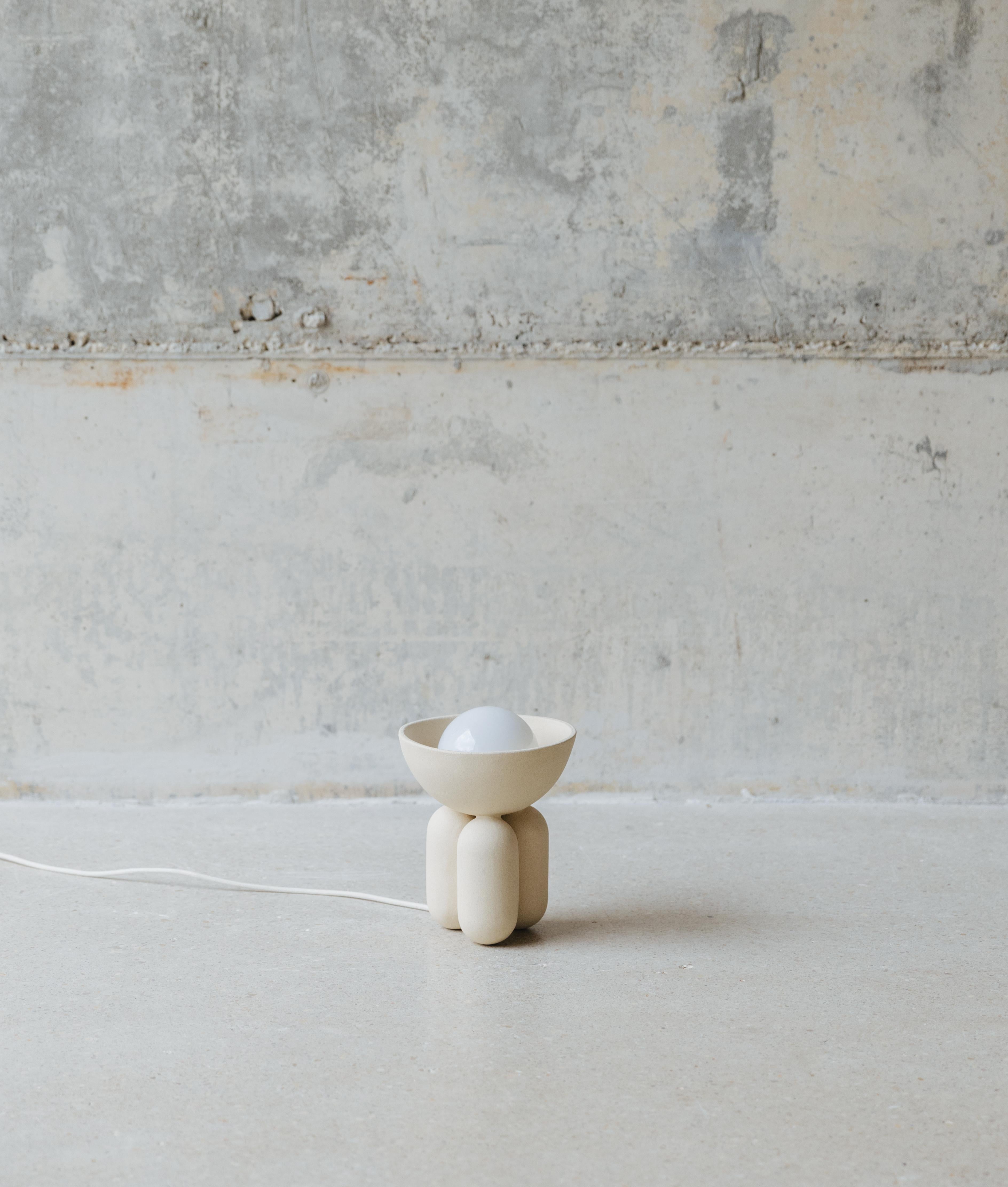 Almond Small Moor Half Sphere Lamp by Lisa Allegra
Dimensions: ø 20 x 27 cm.
Materials: Ceramic.

Also available in Licorice color and in different sizes. Please contact us.

Born in 1986 in Paris, Lisa Allegra has earned in 2010 a degree in