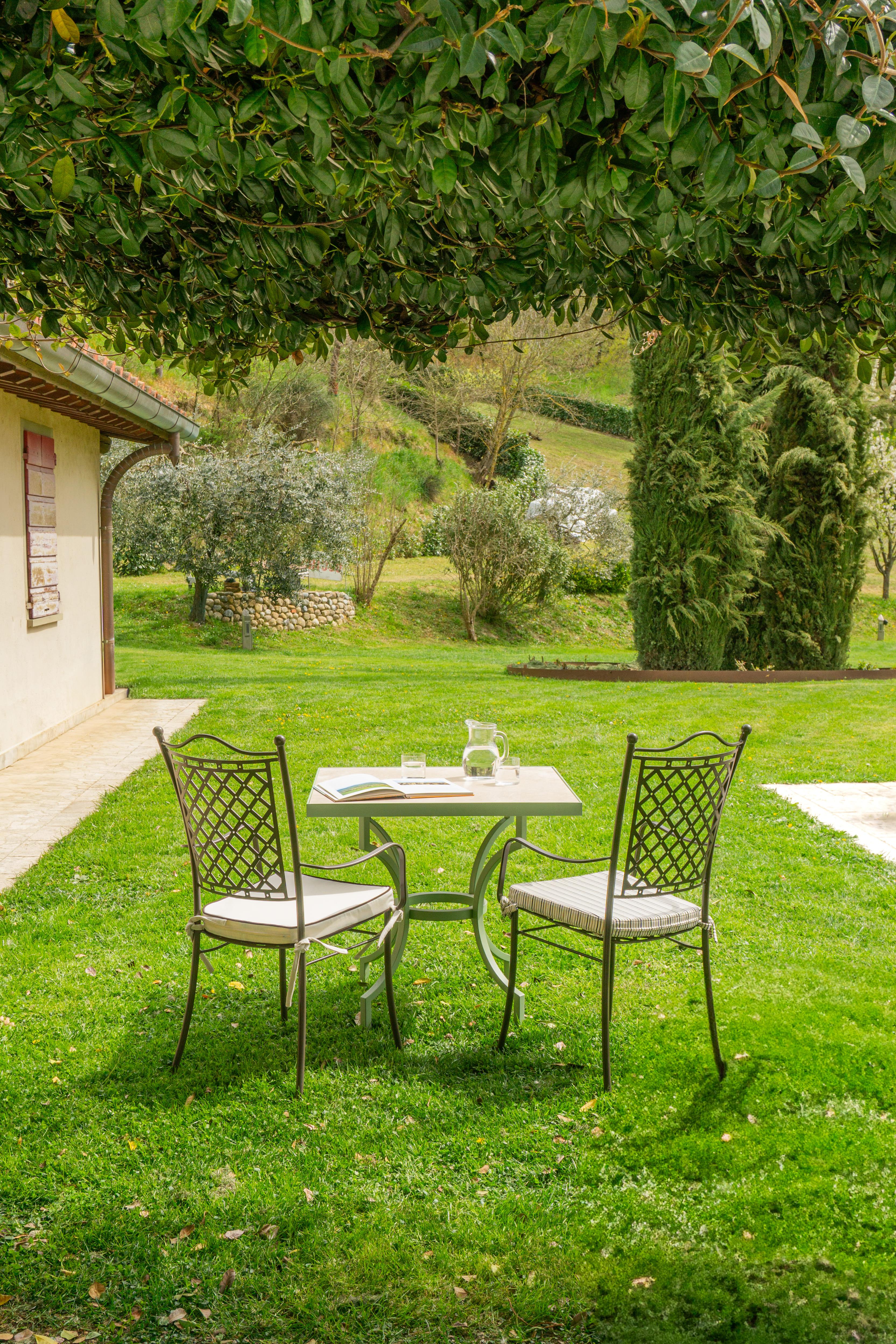 Alnilam - Italian Outdoor Travertine Top Table with Hand-Bent Metal ...