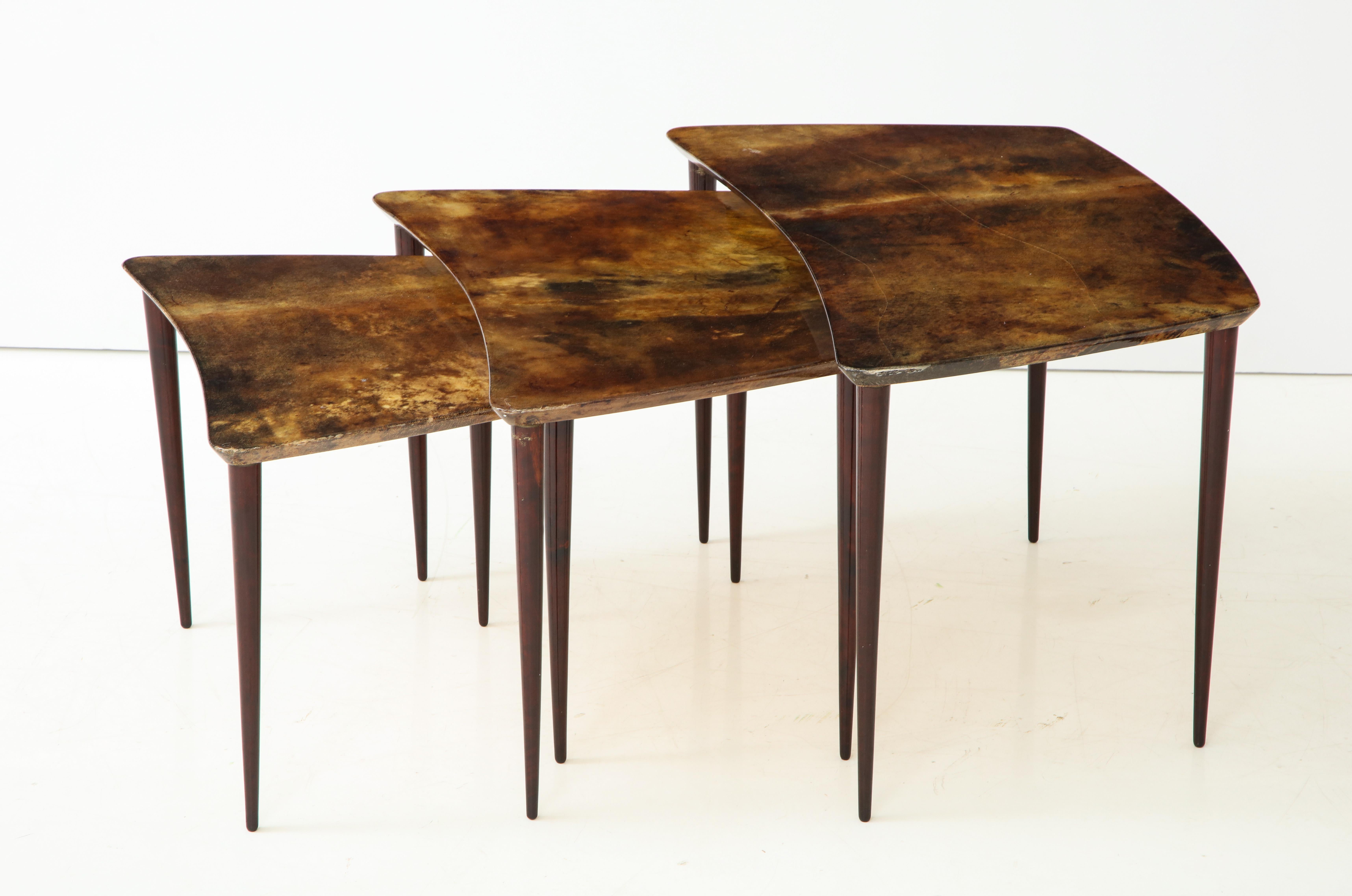 Trio of Italian goatskin or parchment nesting tables, designed by Aldo Tura, Italy, circa 1950s. The large table measures 16.25