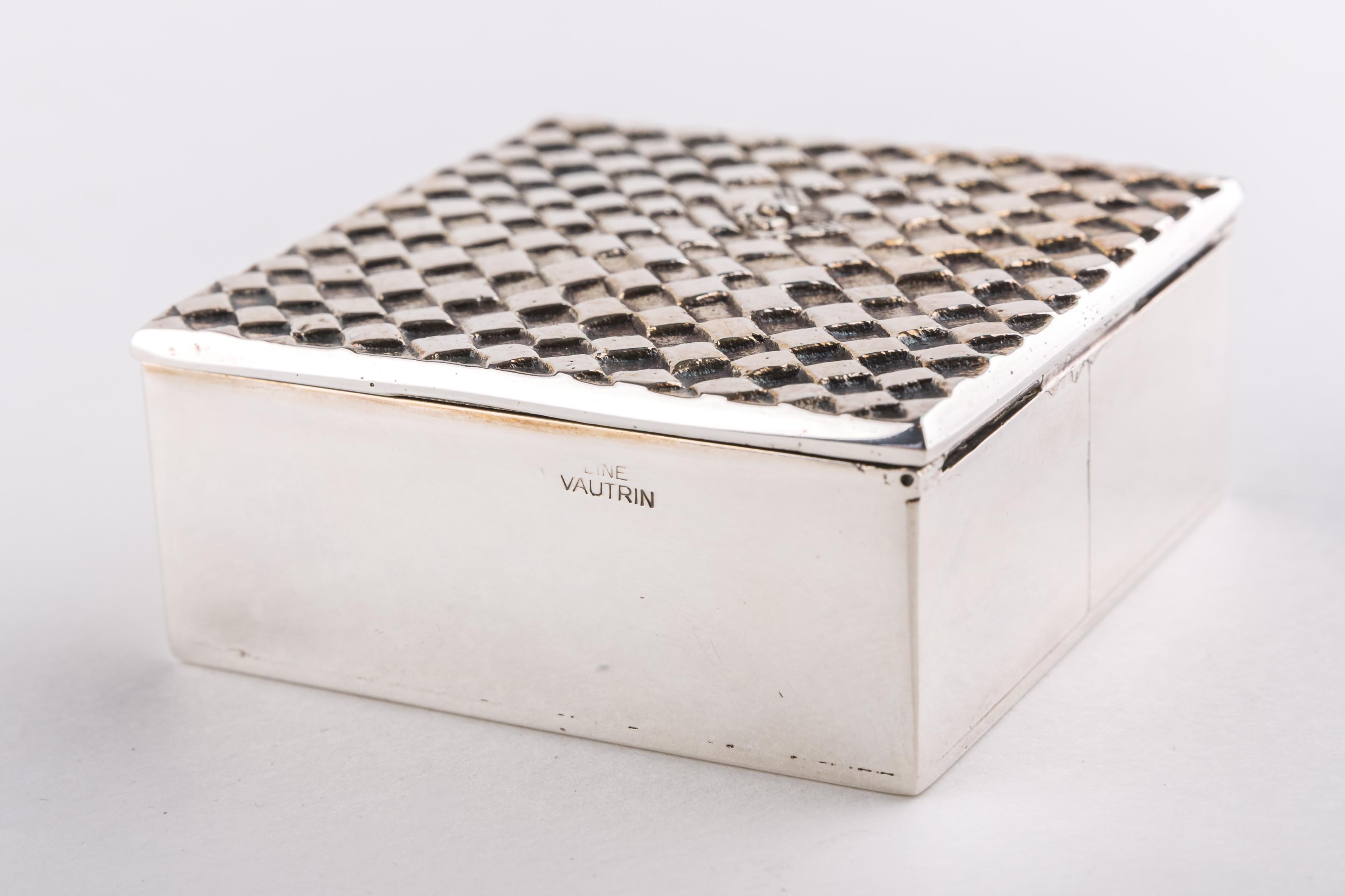 A rare silvered bronze box by French designer and decorator Line Vautrin.
The subject depicts a man alone in hundreds of squares hence the title of the item 