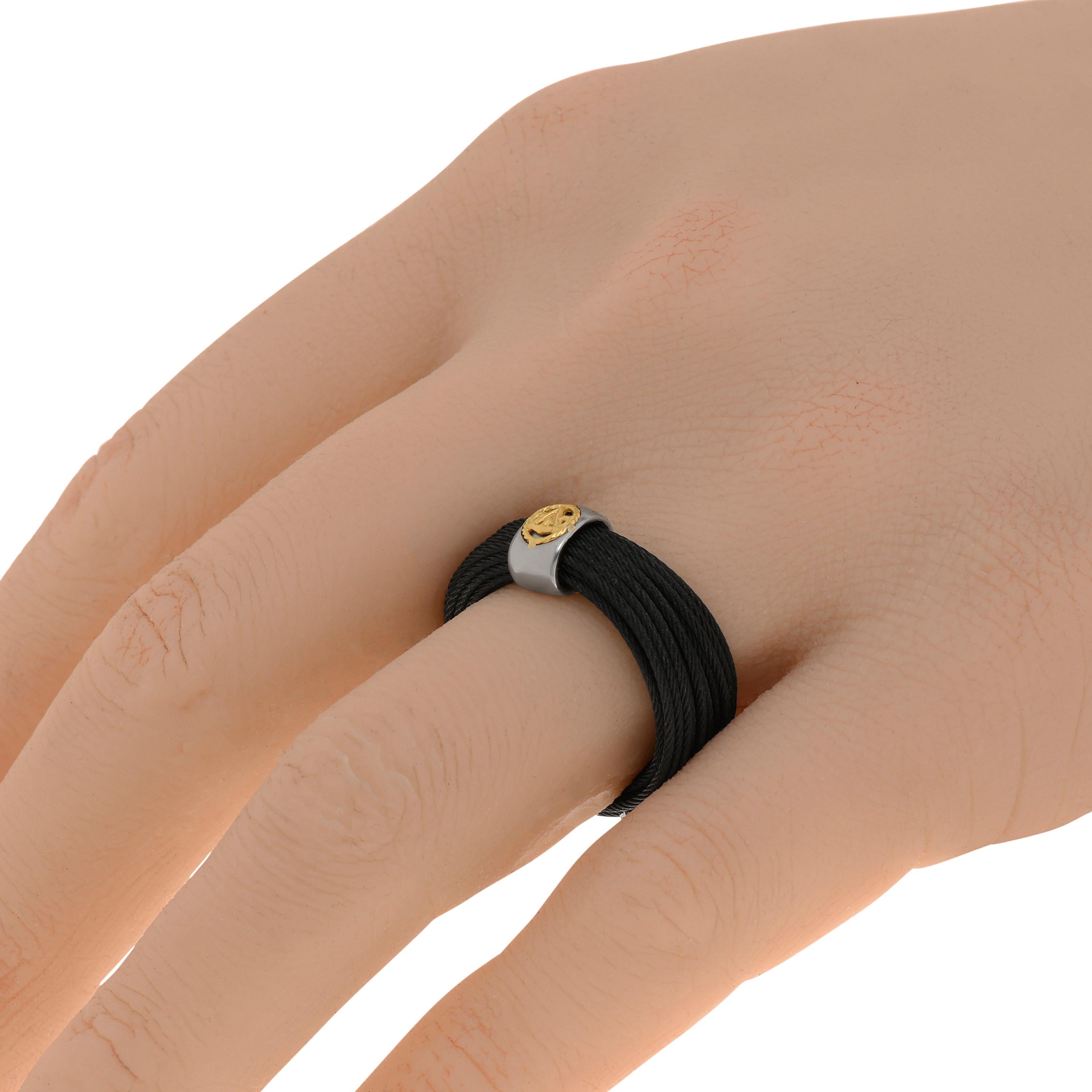 Alor stainless steel and 18K yellow gold cable band ring features layered black micro cables. The ring size is 7 (54.4). The band width is 7.7mm. The weight is 6.7g.
