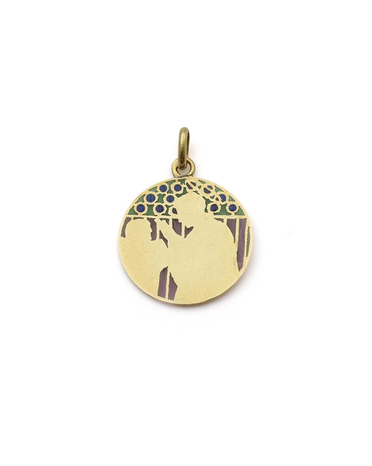 Aloysius de Gonzaga enamel pendant in 18 karat gold. Art Nouveau religious medal depicting a haloed Saint Louis Gonzaga wearing the Jesuit cassock. He meditates before death. The upper part is decorated with green and blue plique-à-jour enamels. The