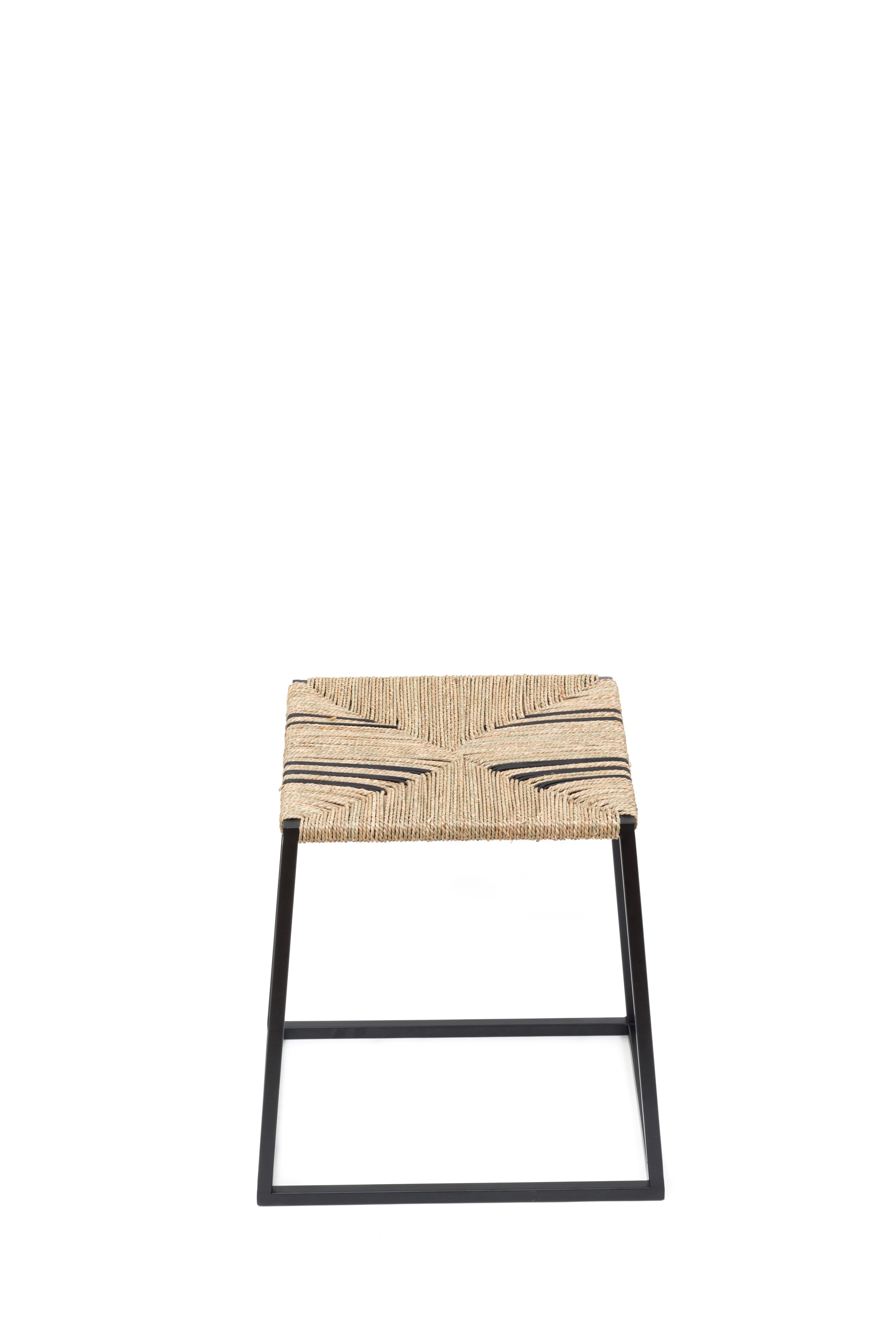 Alp Stool B 105 by Alp Design
Designer: Annick L Petersen.
Dimensions: W 35, D 43, H 45 cm.
Materials: metal base with matt black powder coat finish, seagrass and black leather cord seat using the traditional rush weaving technique.

The alp stool