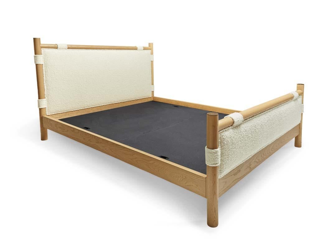 The Chiselhurst bed is an upholstered bed with a solid American Walnut or White Oak frame finished with brass caps. Slats are provided. Available with or without footboard. Shown here in Natural Oak and Alpaca Bouclé. 

The Lawson-Fenning