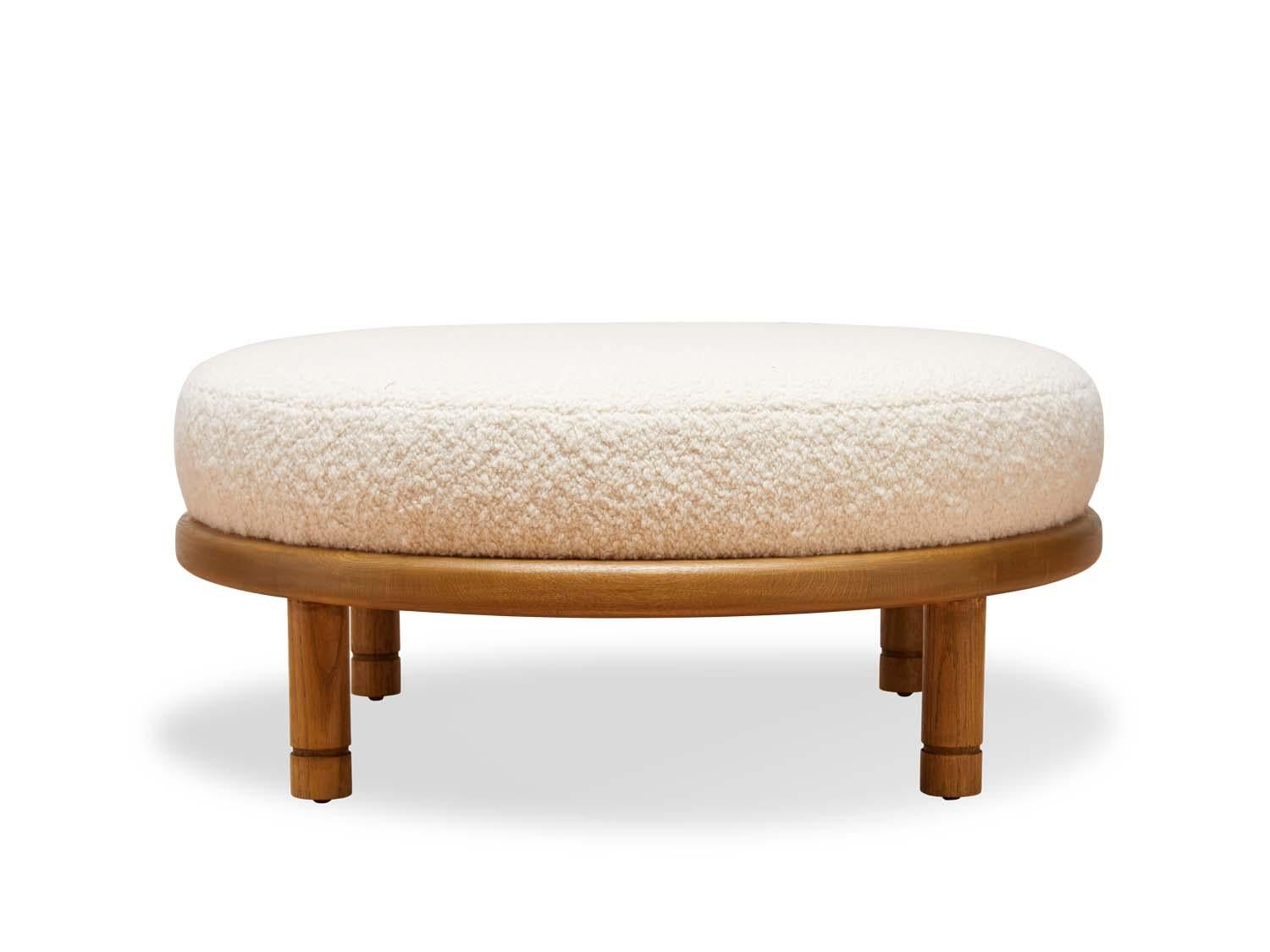 The Moreno Ottoman features a round solid wood base with four cylindrical legs and an upholstered top. Available in American walnut or white oak. Shown here in natural oak. Shown here in White Alpaca Bouclé and Oiled Oak. 

The Lawson-Fenning