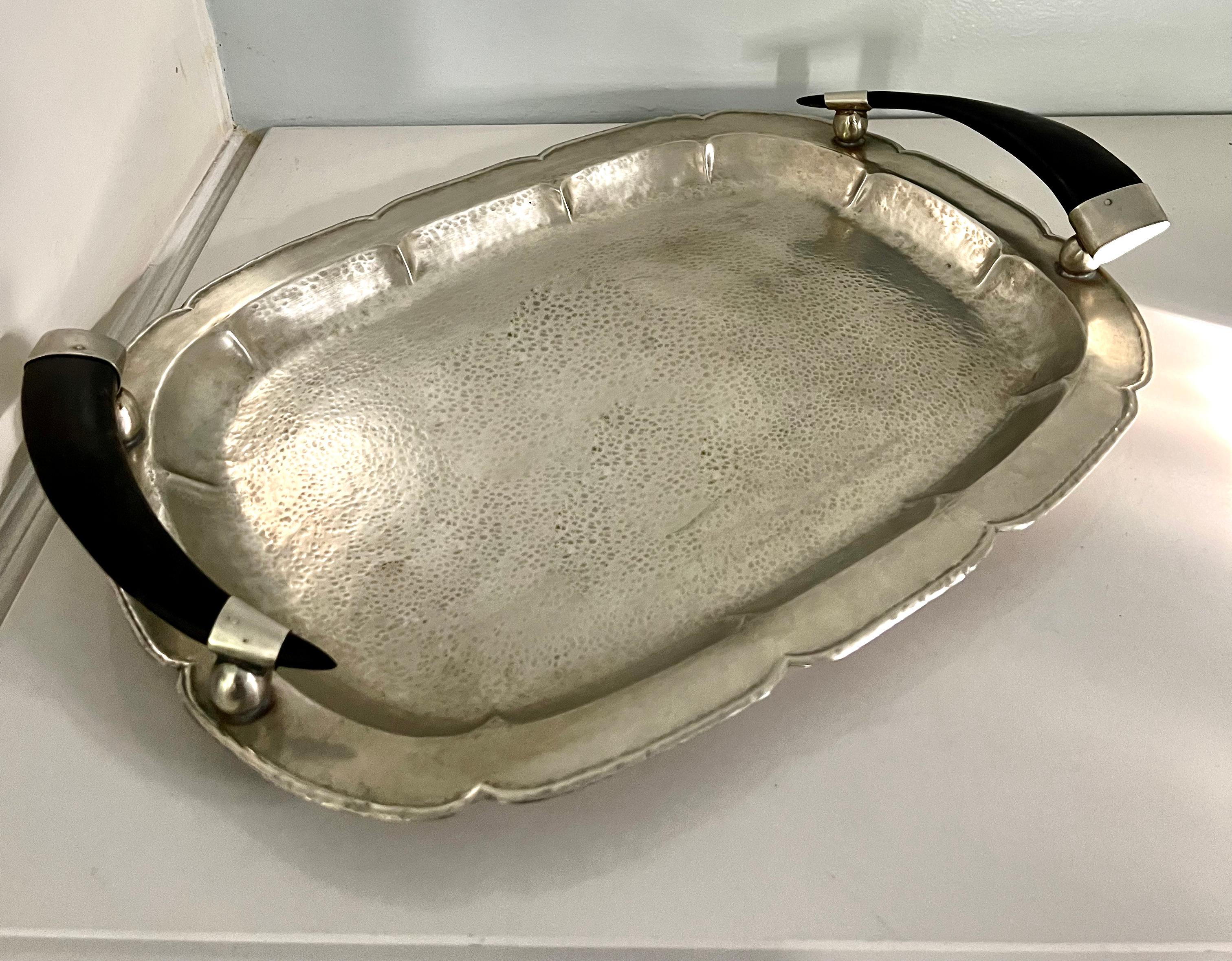 A wonderful Hammered Silver tray with Horn Handles - hand crafted in Argentina, made with carefully placed studs. We have left much of the patination as it serves the piece well.

A compliment to many settings, but we find it most attractive in a