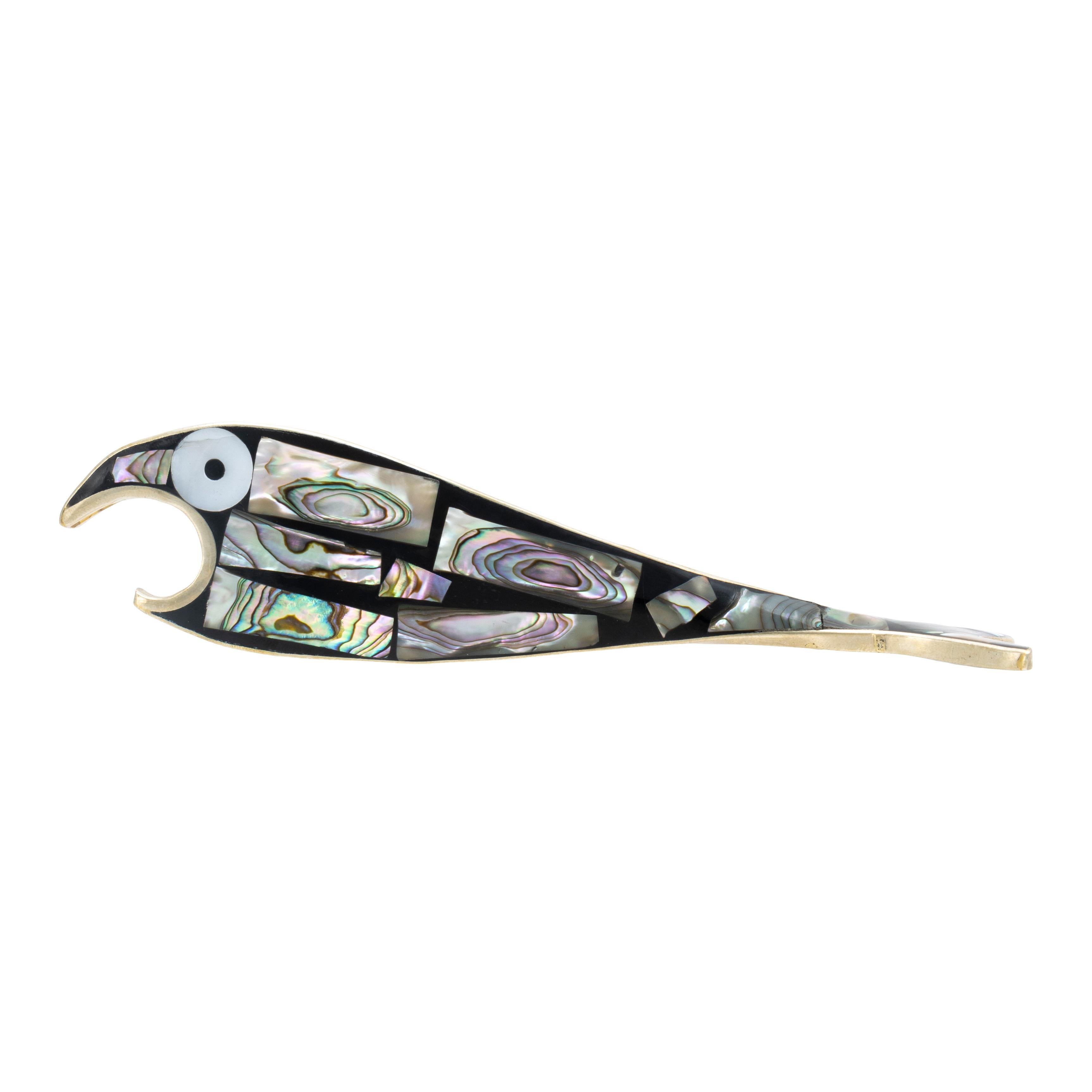 Alpaca silver fish bottle opener. Featuring Blue Pacific abalone inlay, contrasted nicely against the black backdrop of the piece and large white and black shell eyes. Its body is flat with curved open mouth that constitutes the bottle opener. Body