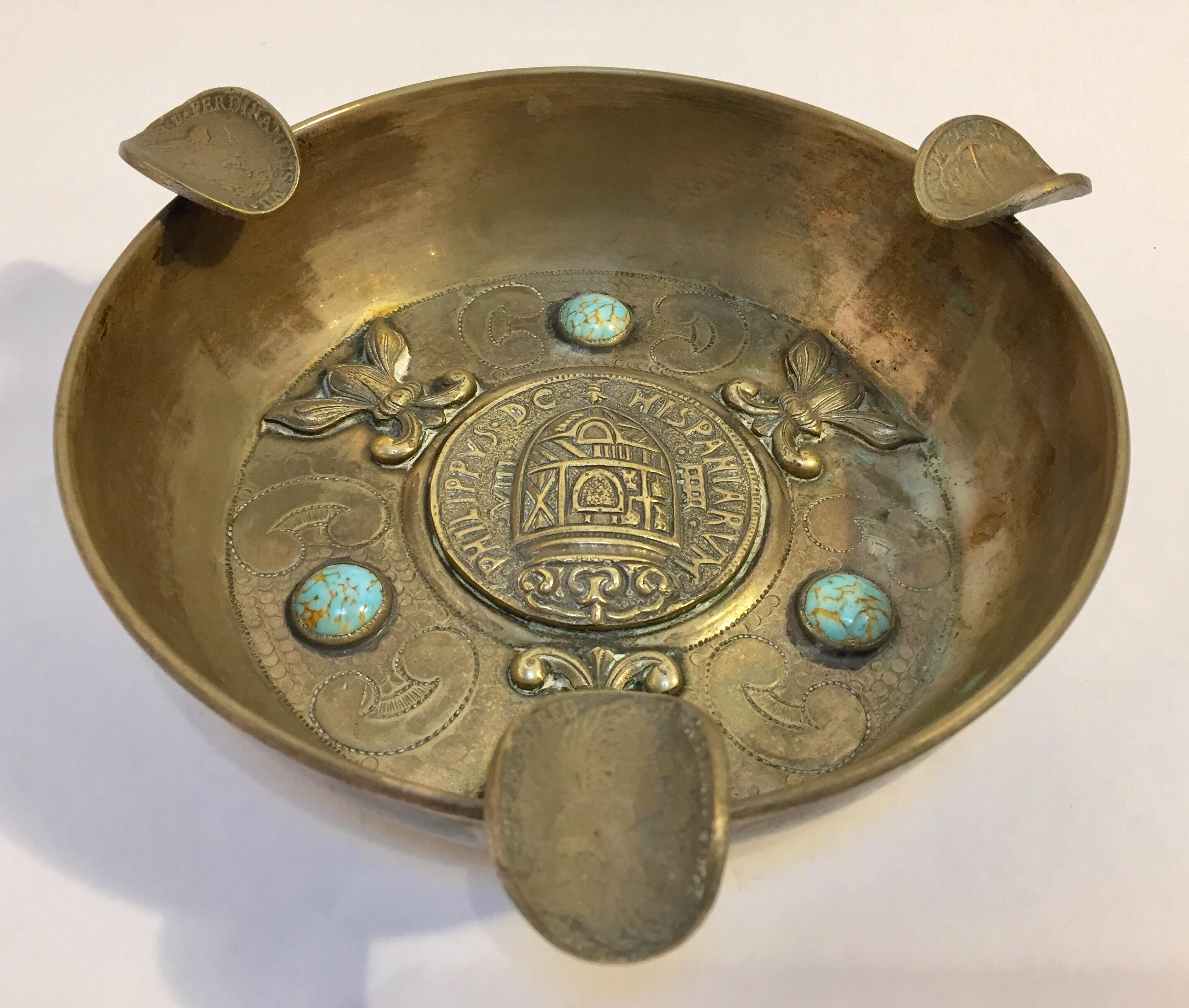 If you're smoking cigars, chances are you enjoy the good things in life. This antique Alpaca coin and turquoise ashtray falls in the category of luxe. 
Handcrafted in South America so each ashtray is totally unique in nature due to the coins