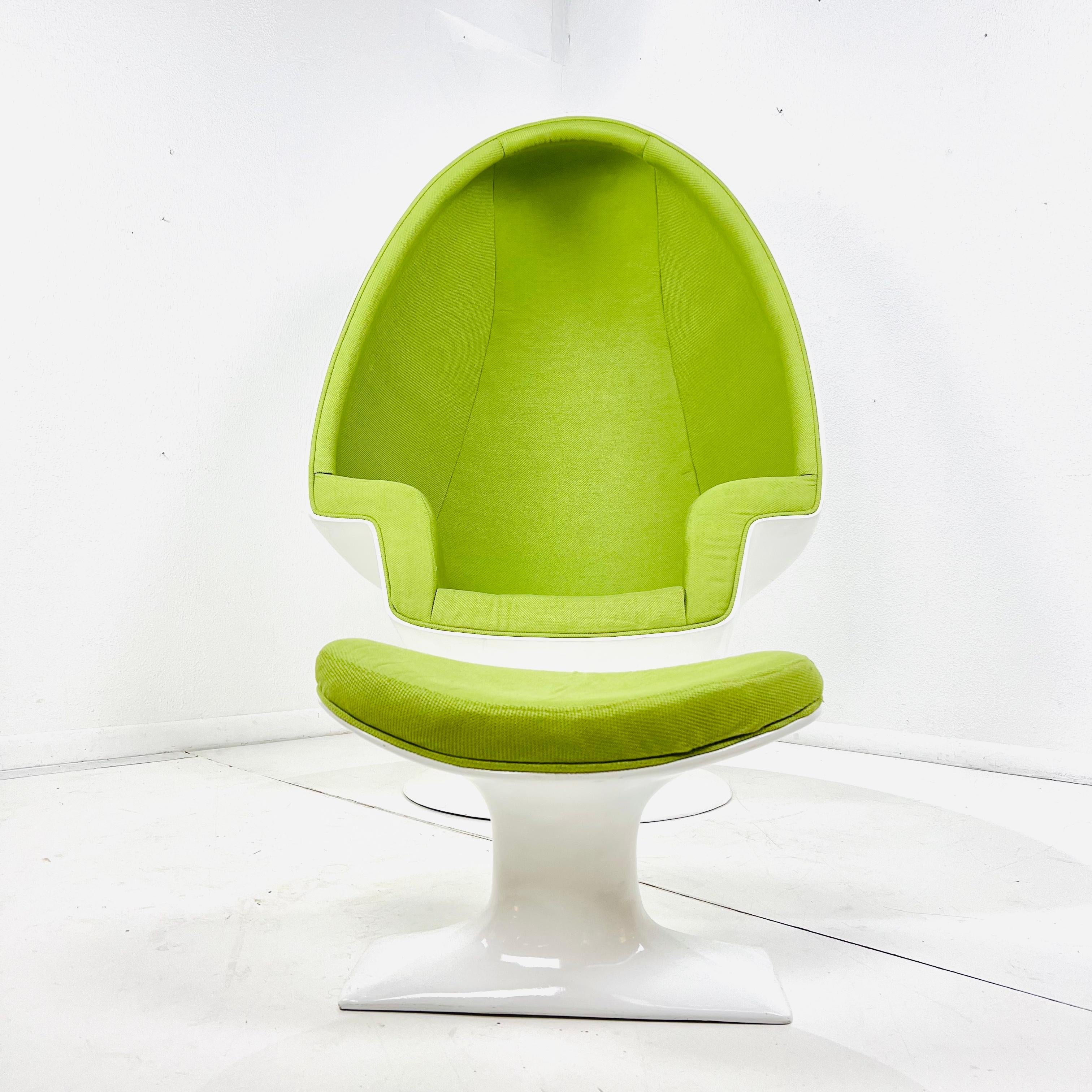 The Alpha Egg Chair seamlessly blends 60s-inspired design with contemporary comfort. Its striking style features deep, interior curves in a vibrant color, encased in a smooth, rounded fiberglass shell. The chair swivels on a weighted base, adding a