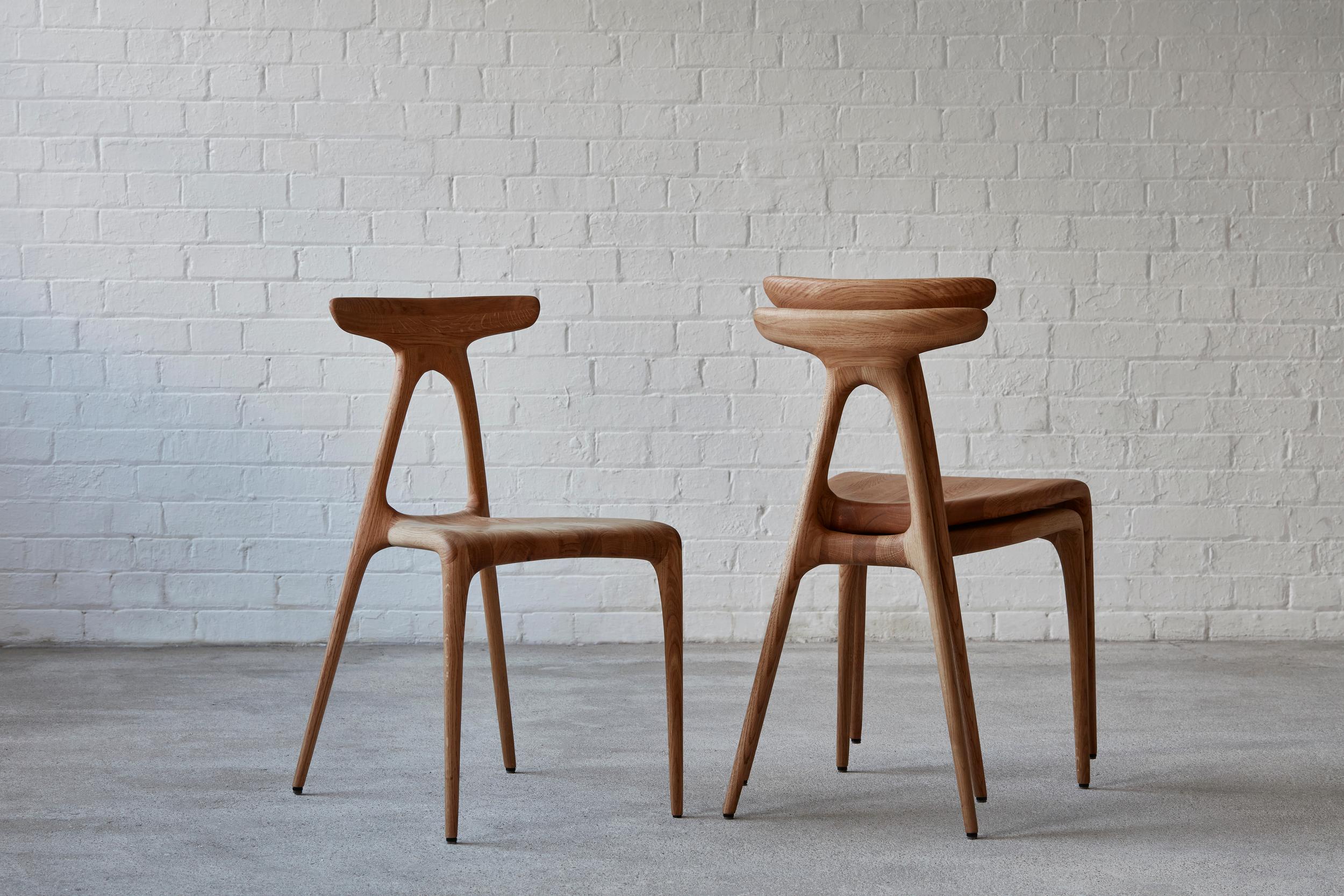 A contemporary solid-wood all-purpose stackable chair produced using the latest production technologies of shaped wooden furniture. The design boasts a strong architectural gesture that gives the chair its inherent strength: the a shaped structure