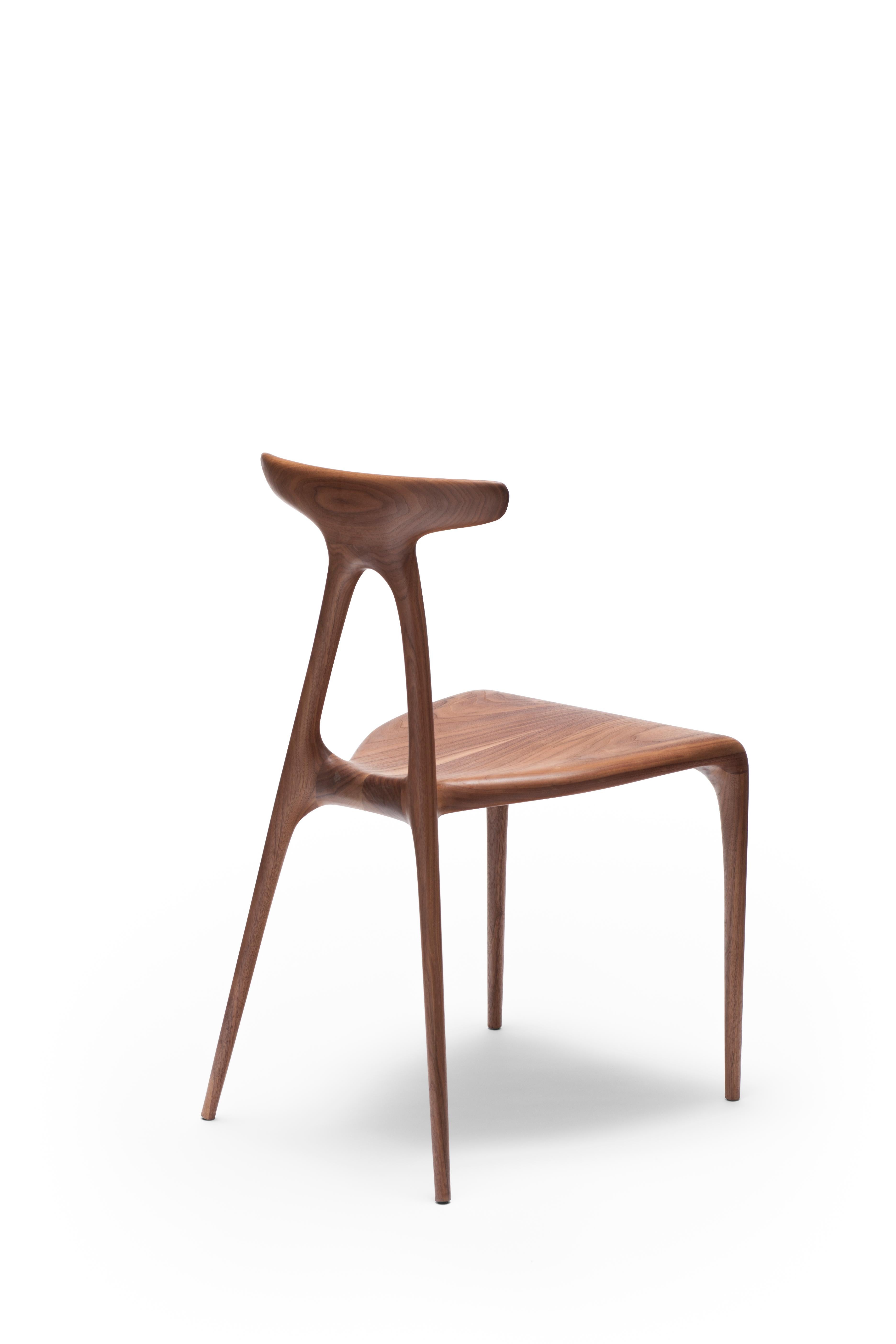 A contemporary solid-wood all-purpose stackable chair produced using the latest production technologies of shaped wooden furniture. The design boasts a strong architectural gesture that gives the chair its inherent strength: the a shaped structure