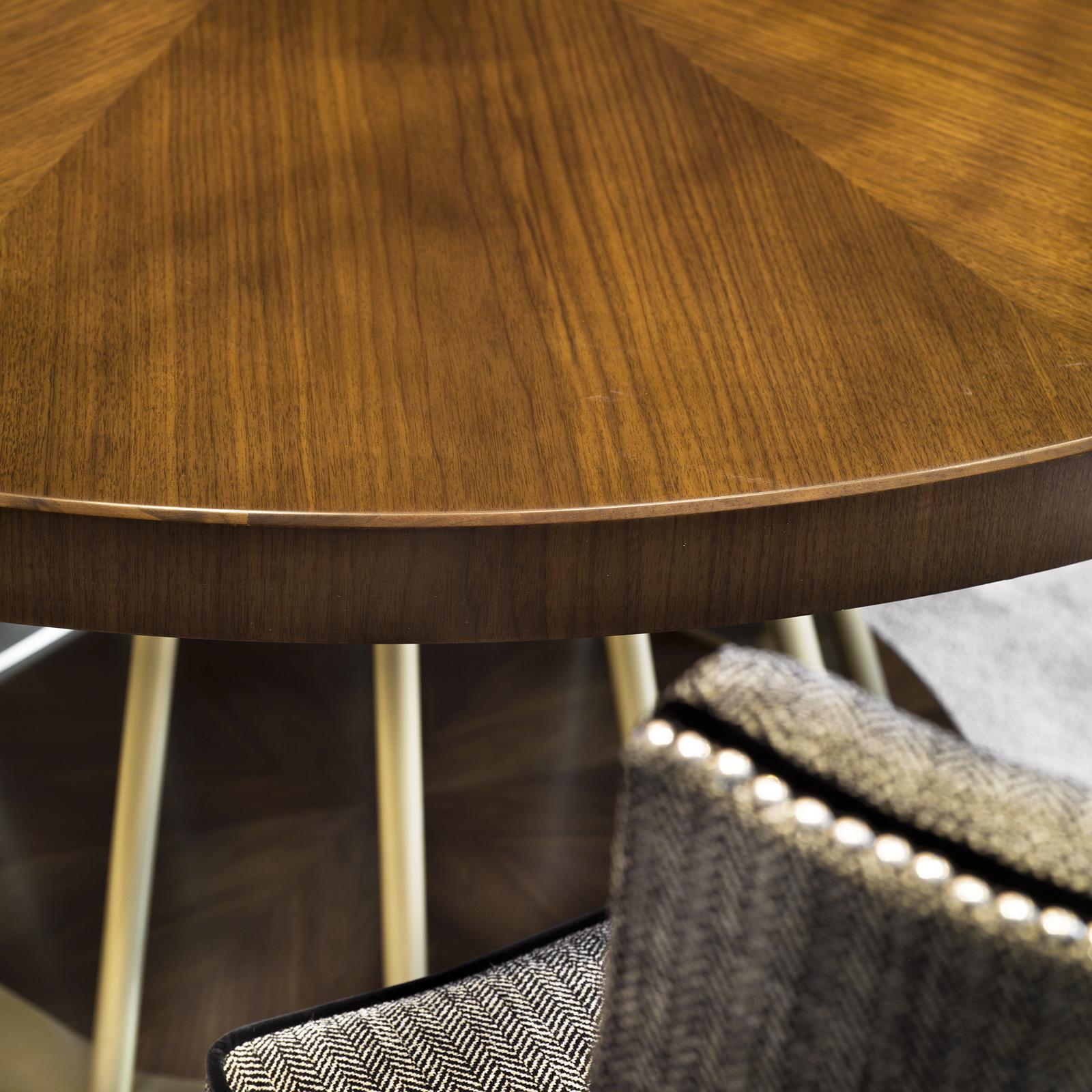 This superb table will be an exquisite addition to a dining room or large entryway, bringing sophistication to any home. The round top in black walnut boasts the natural grain of the wood and occurs also in the base, which features a handcrafted